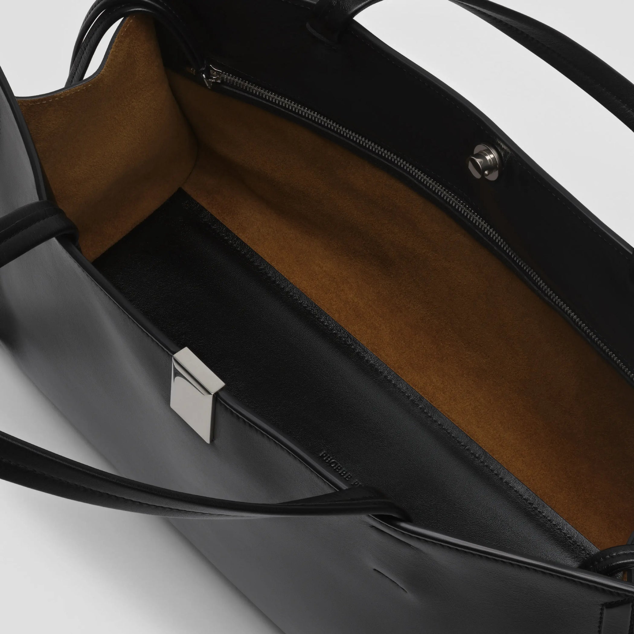 Detail view of medium kit cabas in black leather.
