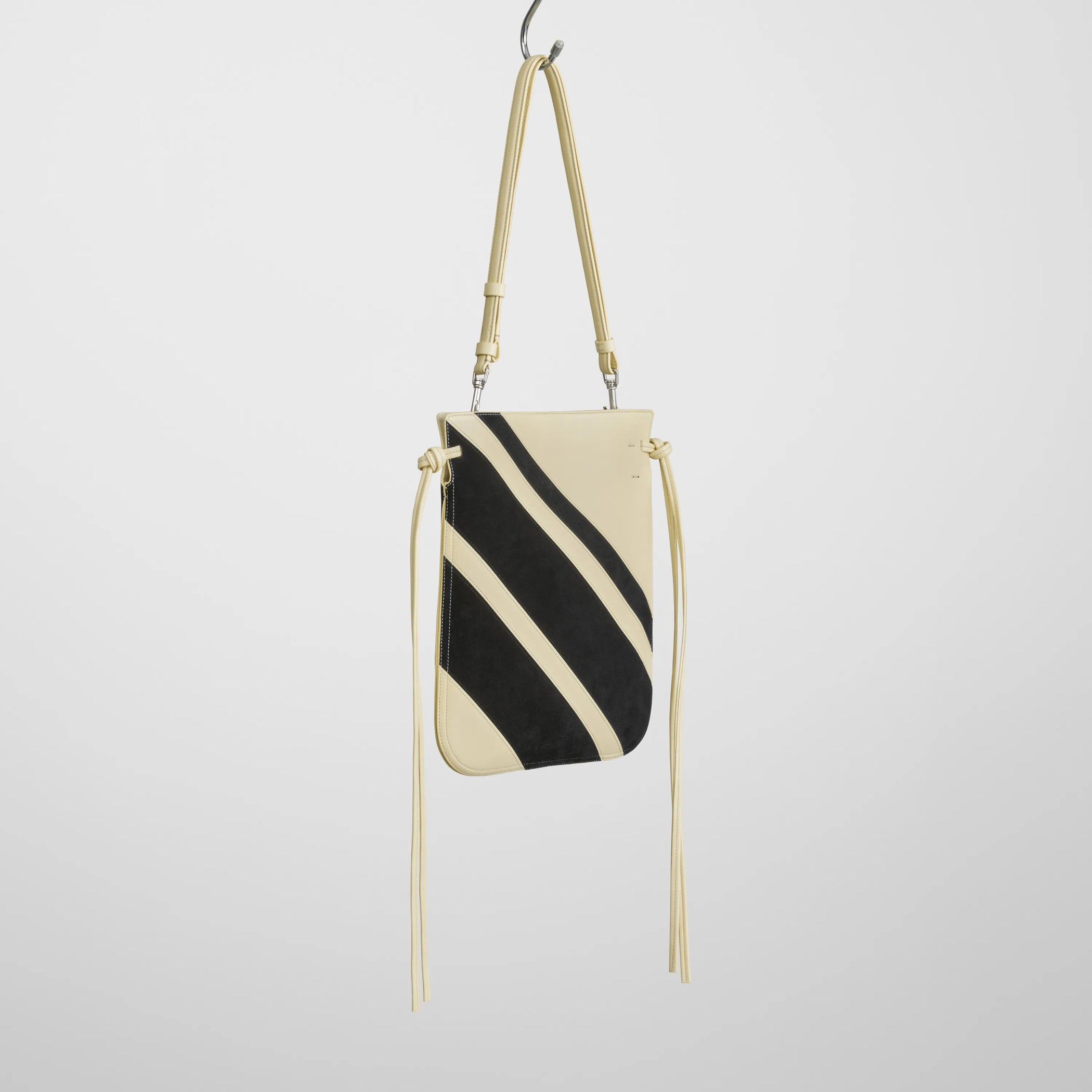 Angled view of gig pouch in black white leather