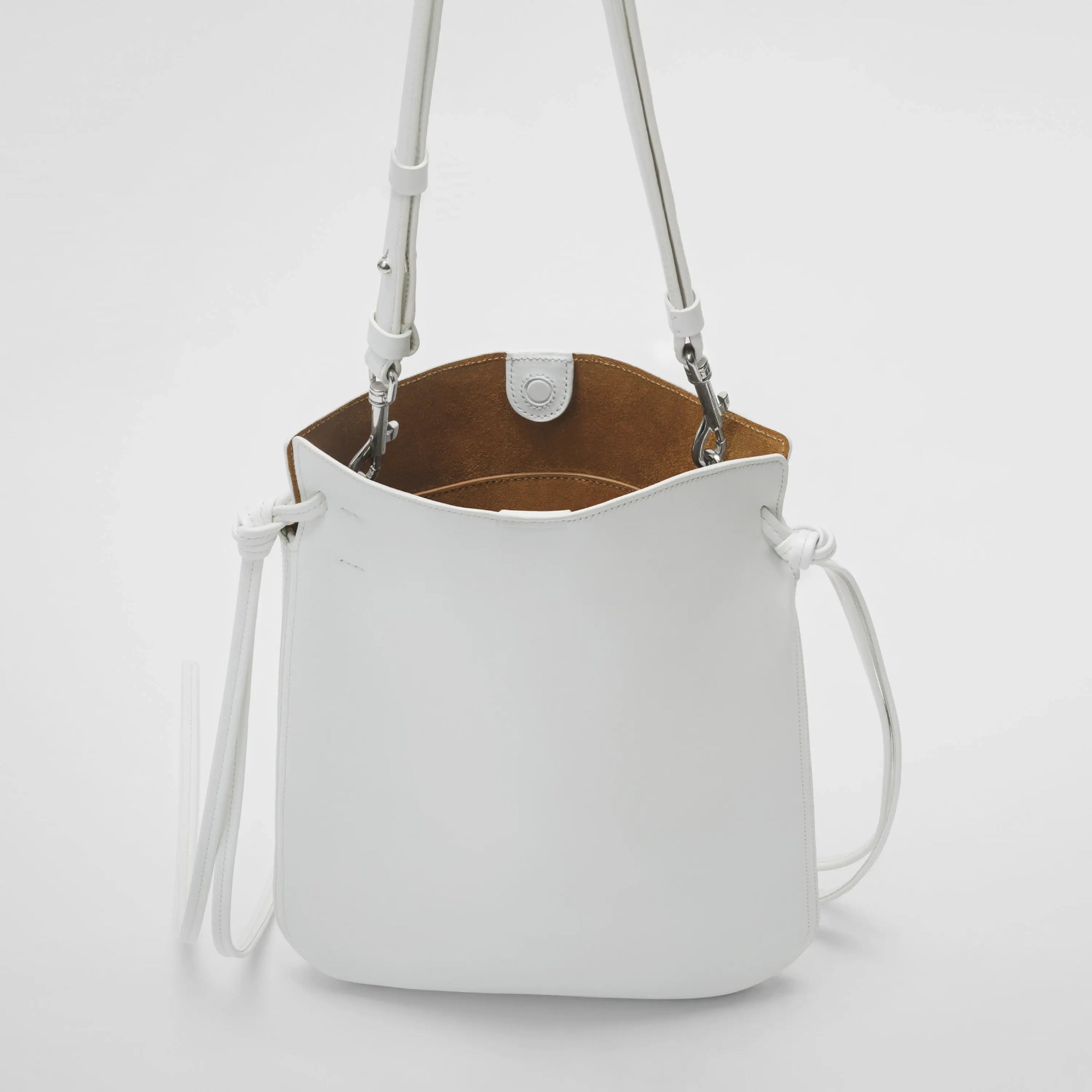 Detailed view of gig pouch in white leather with silver.