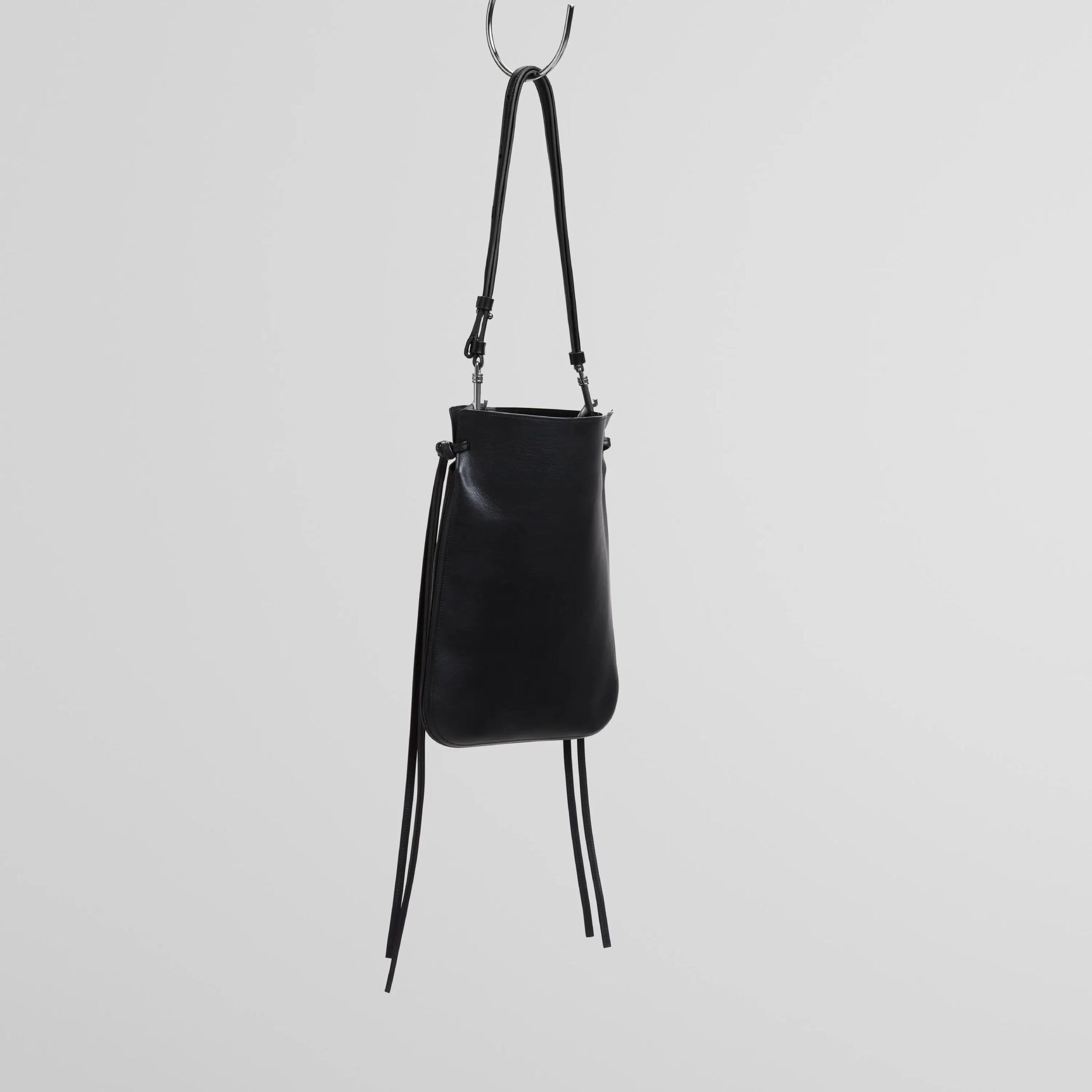 Angled view of gig pouch in black leather with silver.
