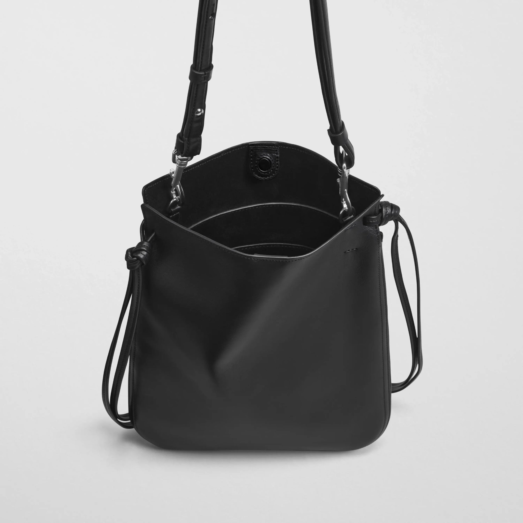 Close up detail view of gig pouch in black leather with silver.