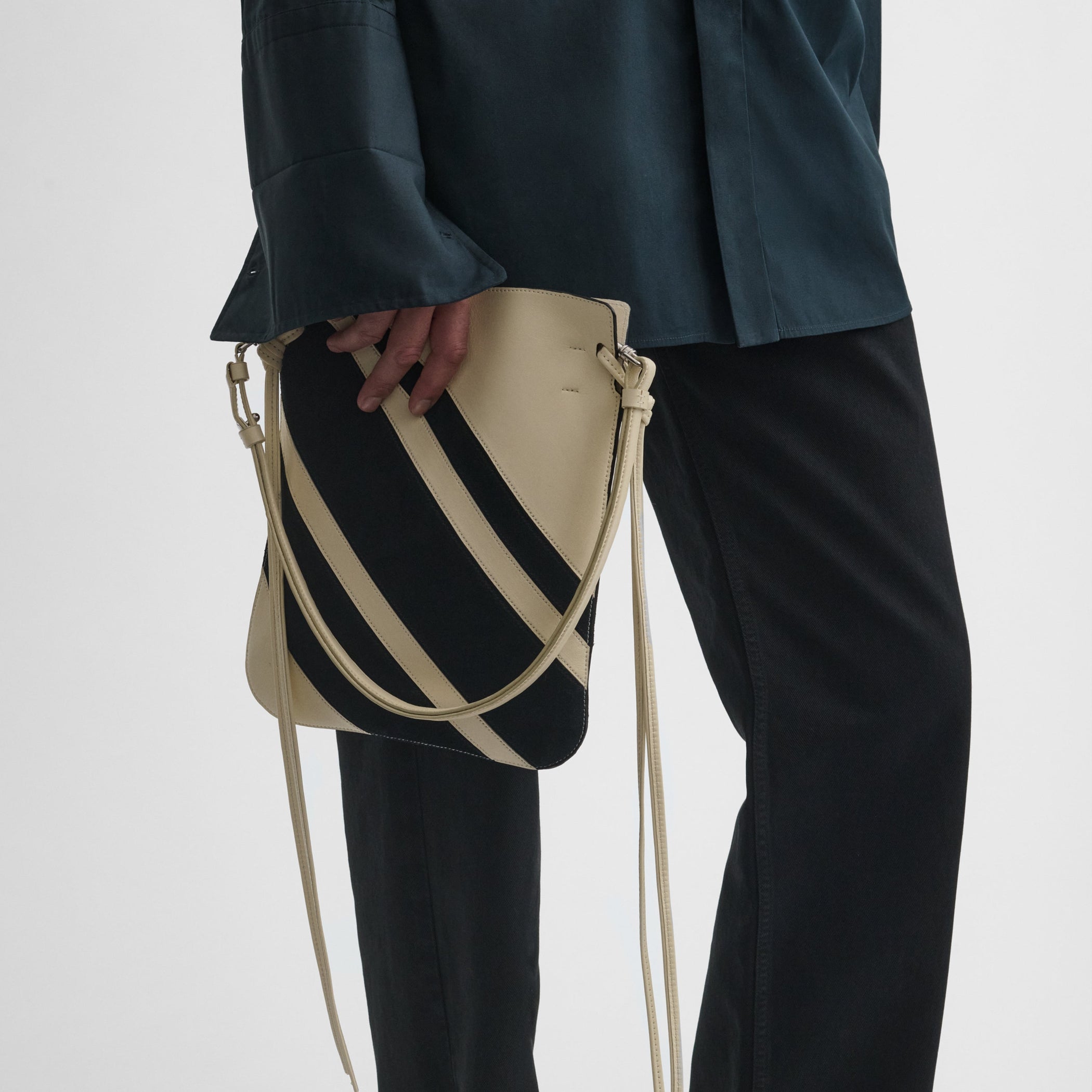 Detail view of model holding the gig pouch in black white leather