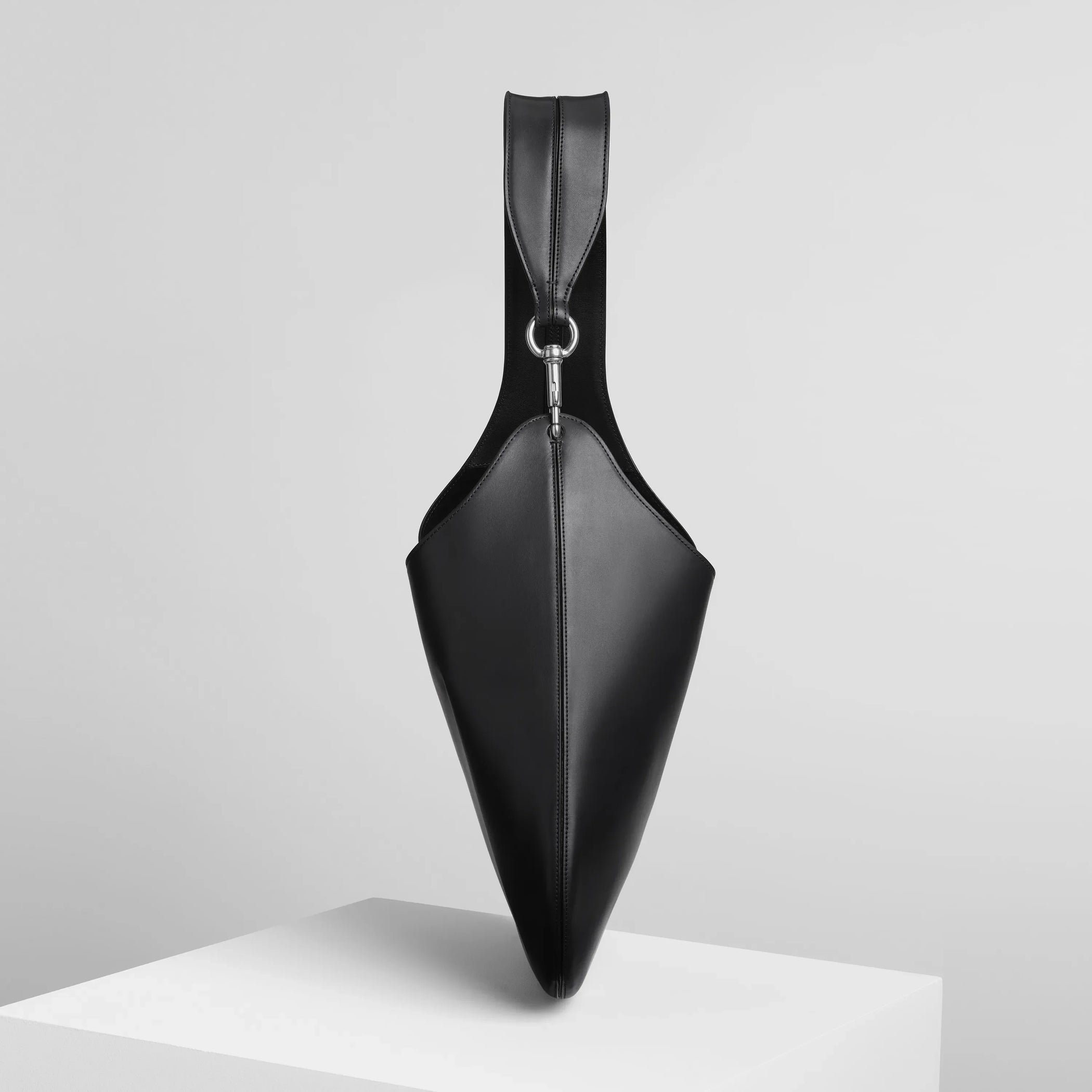 Side view of bean sling bag in black leather.