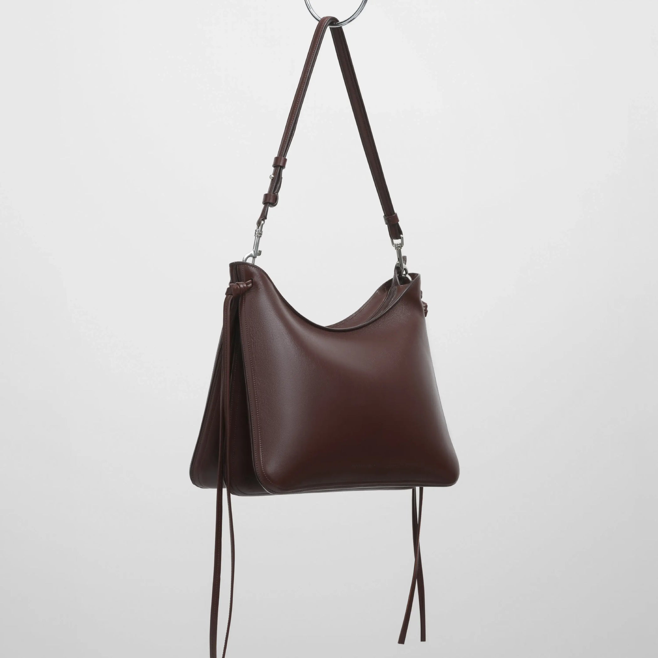 Angled view of gig bag in cognac leather with silver