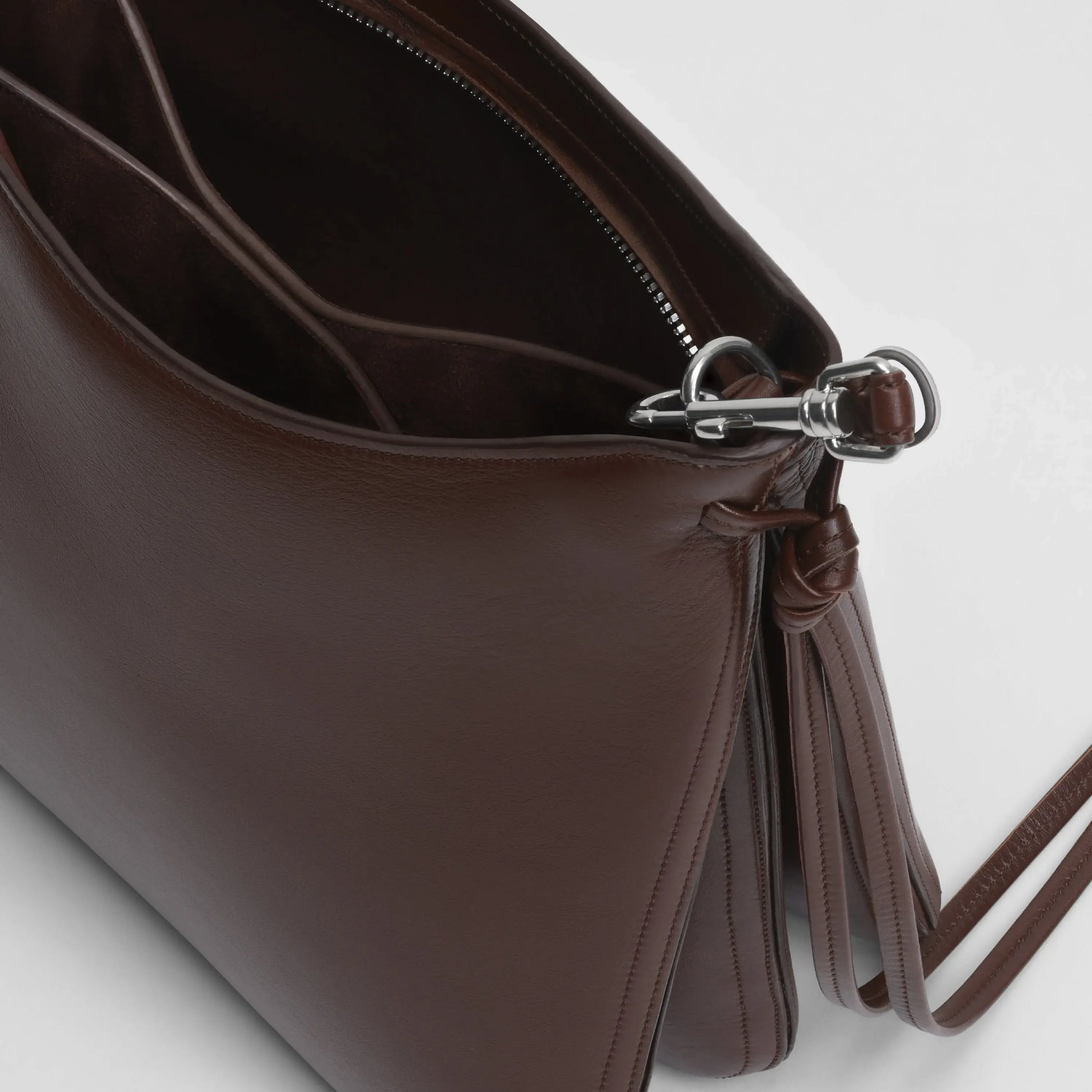 Close up detail view of gig bag in cognac leather with silver