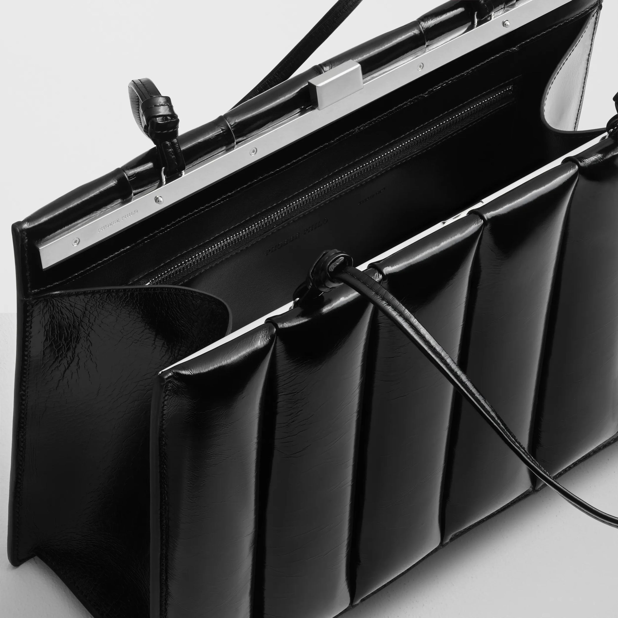Close up detail view of drive bag in black leather.