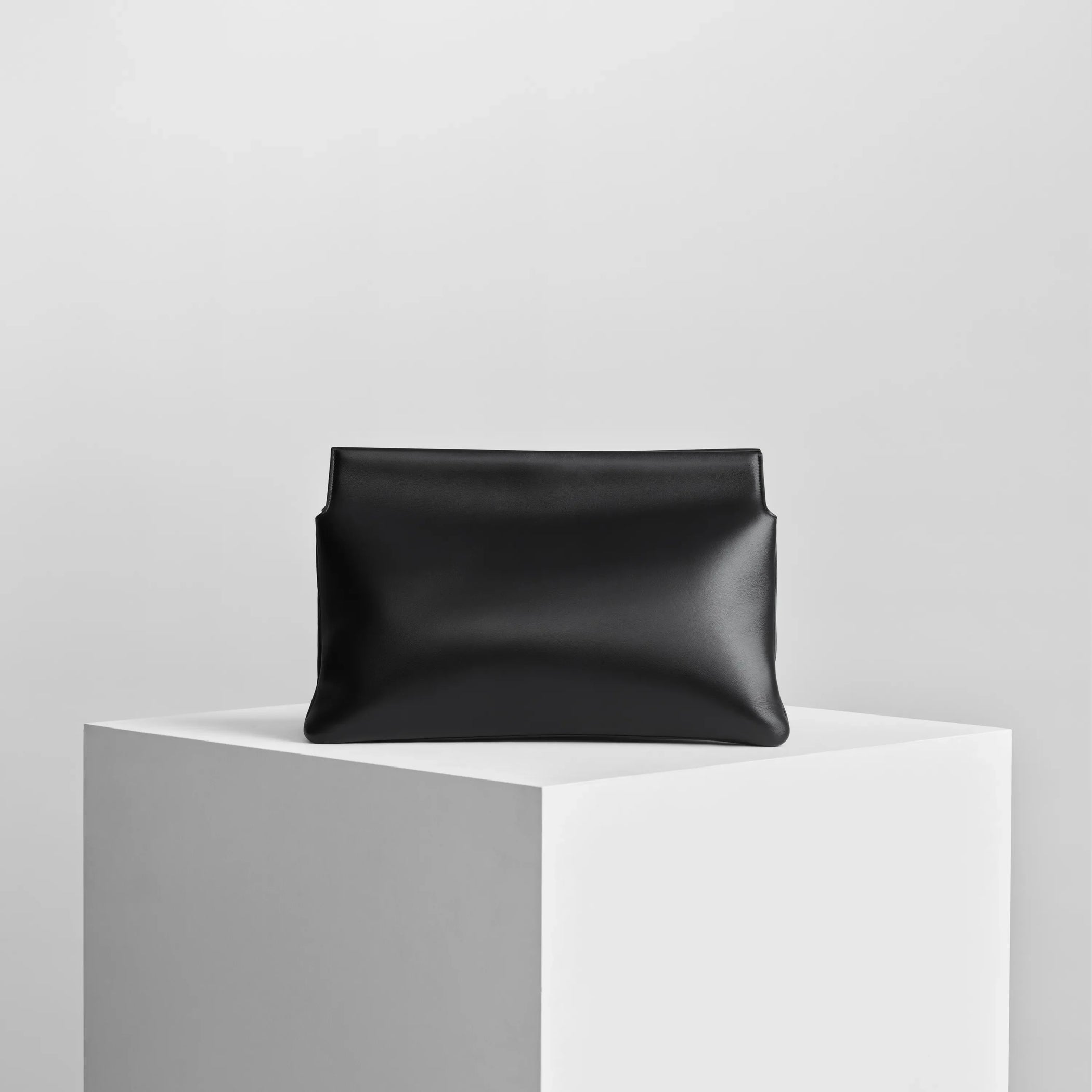 Back view of triplex clutch in black leather with gold.
