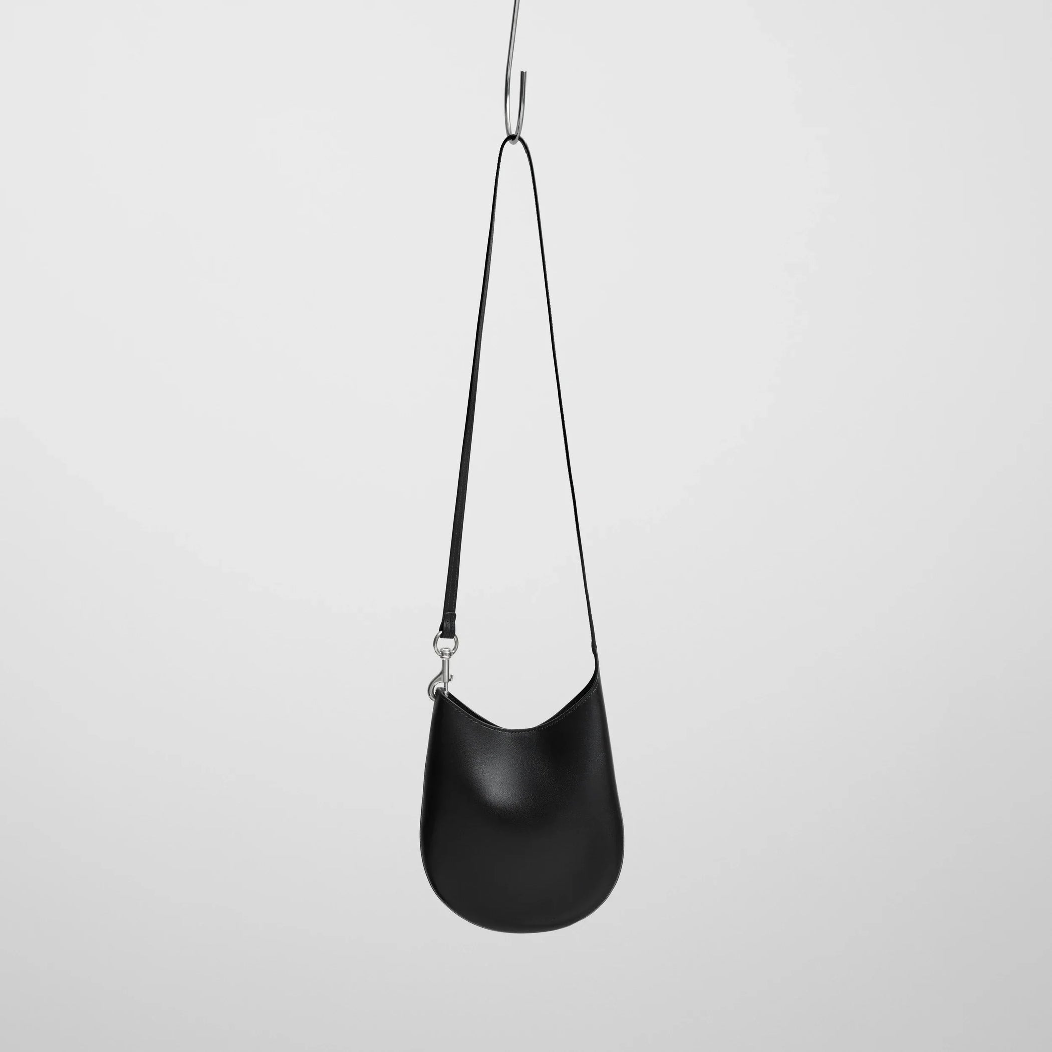 Front view of mini bean sling in black leather.
