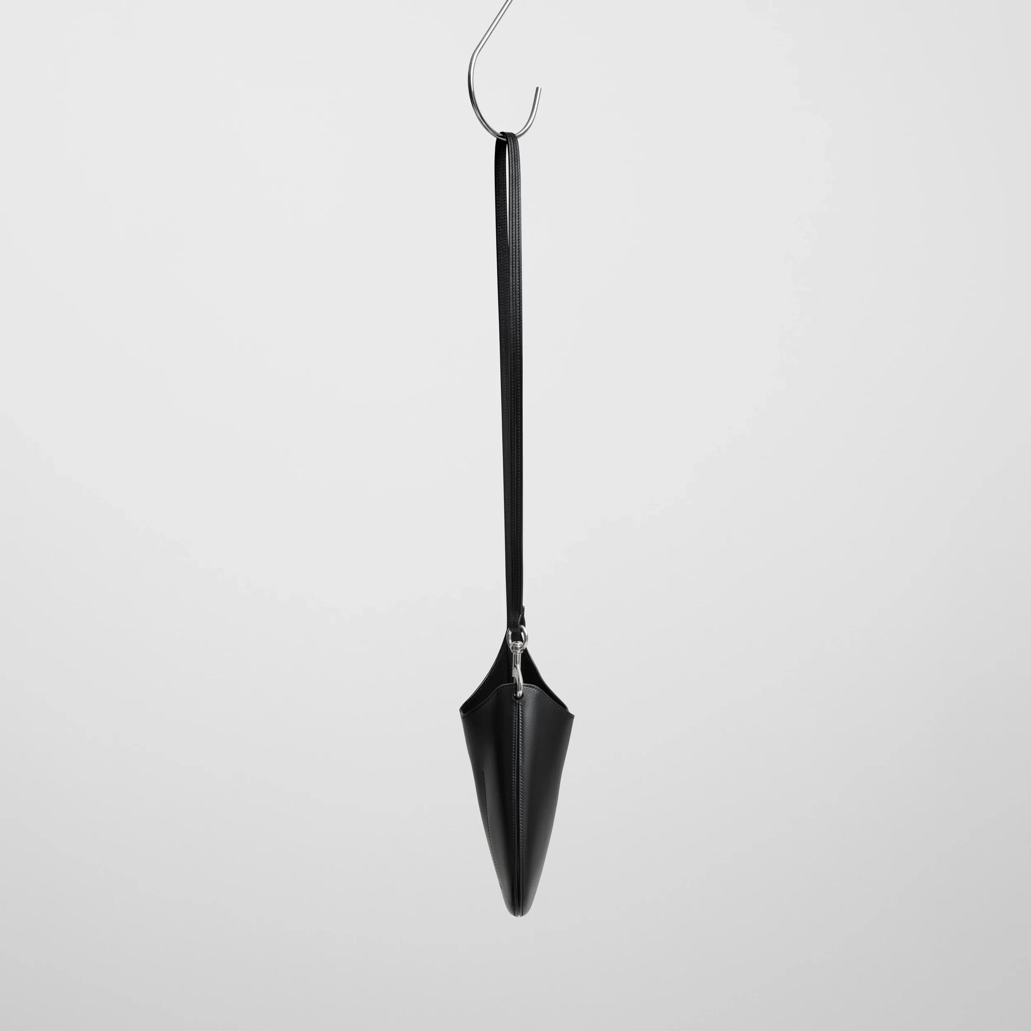 Side view of mini bean sling in black leather.