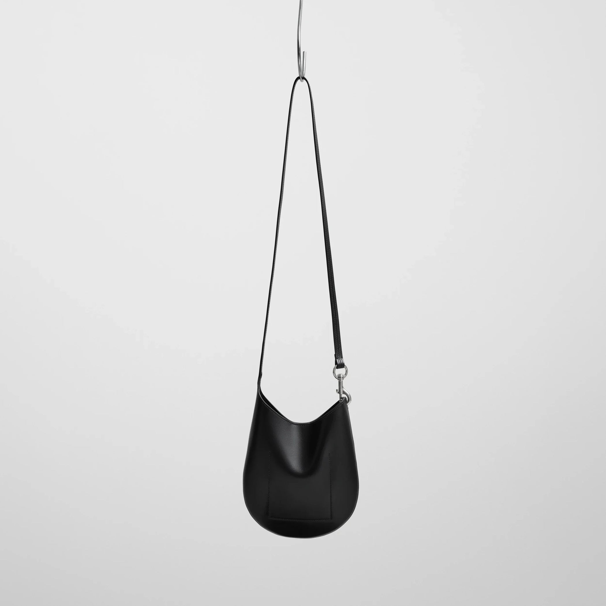 Back view of mini bean sling in black leather.