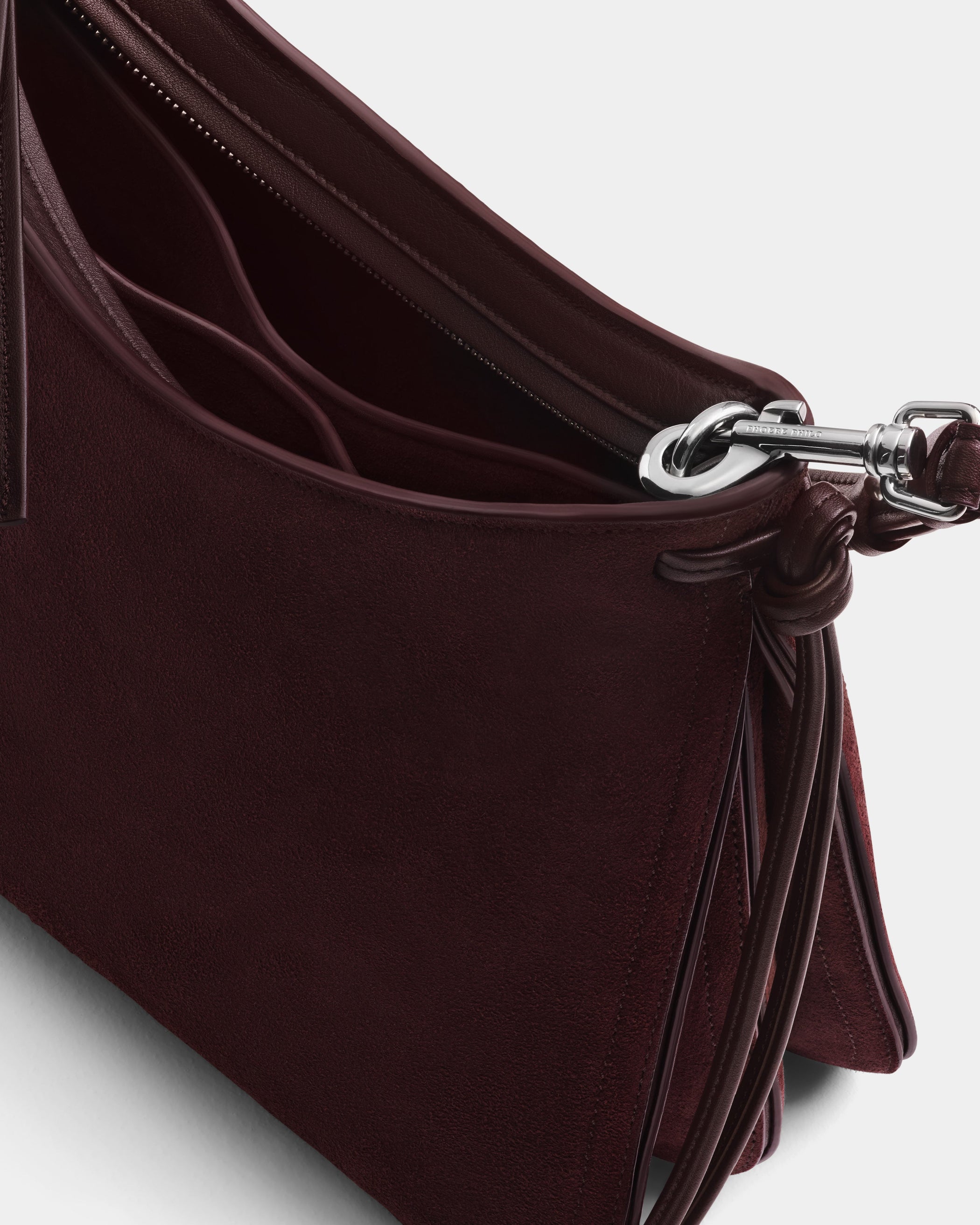 Detail view of SMALL GIG BAG in oxblood suede leather