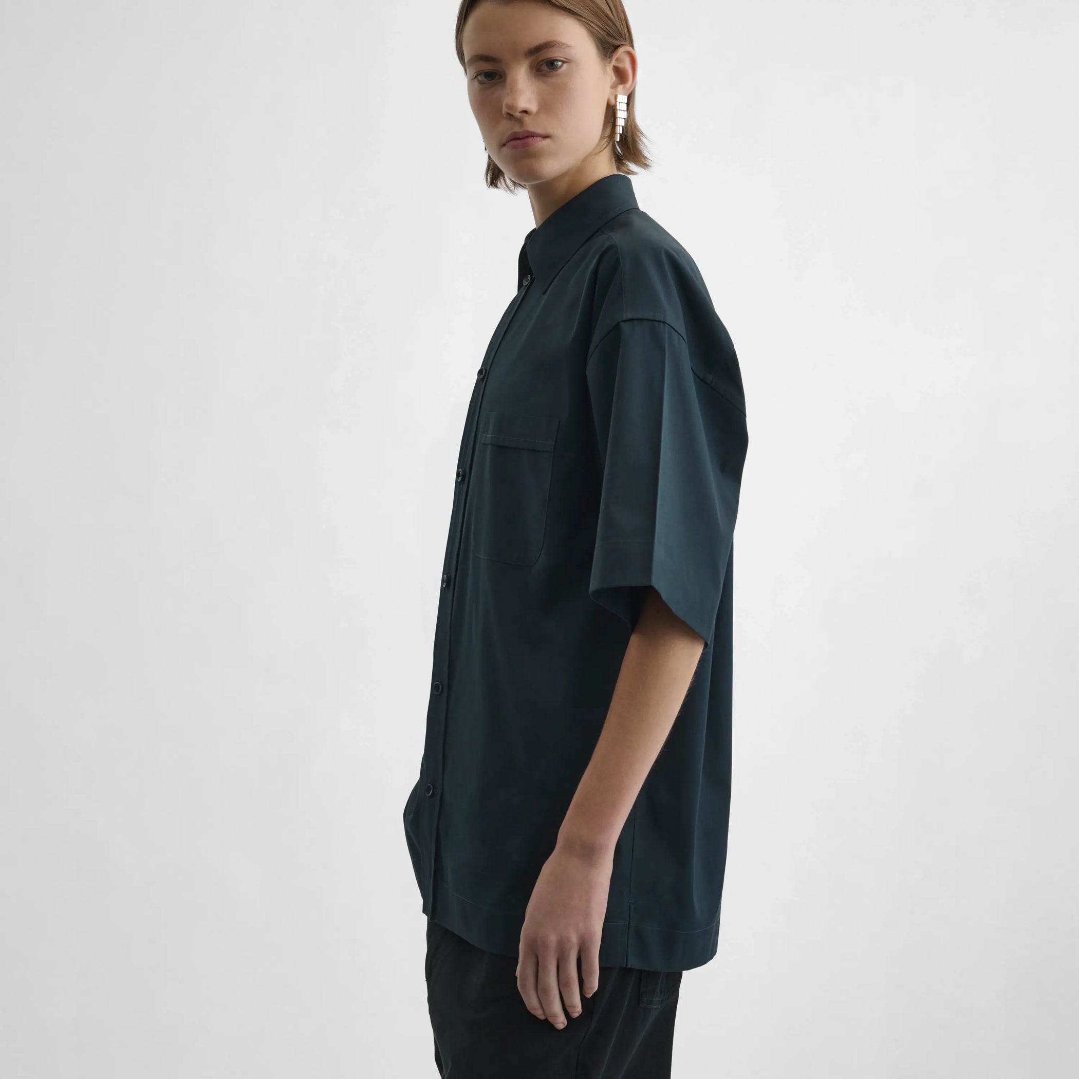 Side view of model wearing Short Sleeve Shirt in midnight.