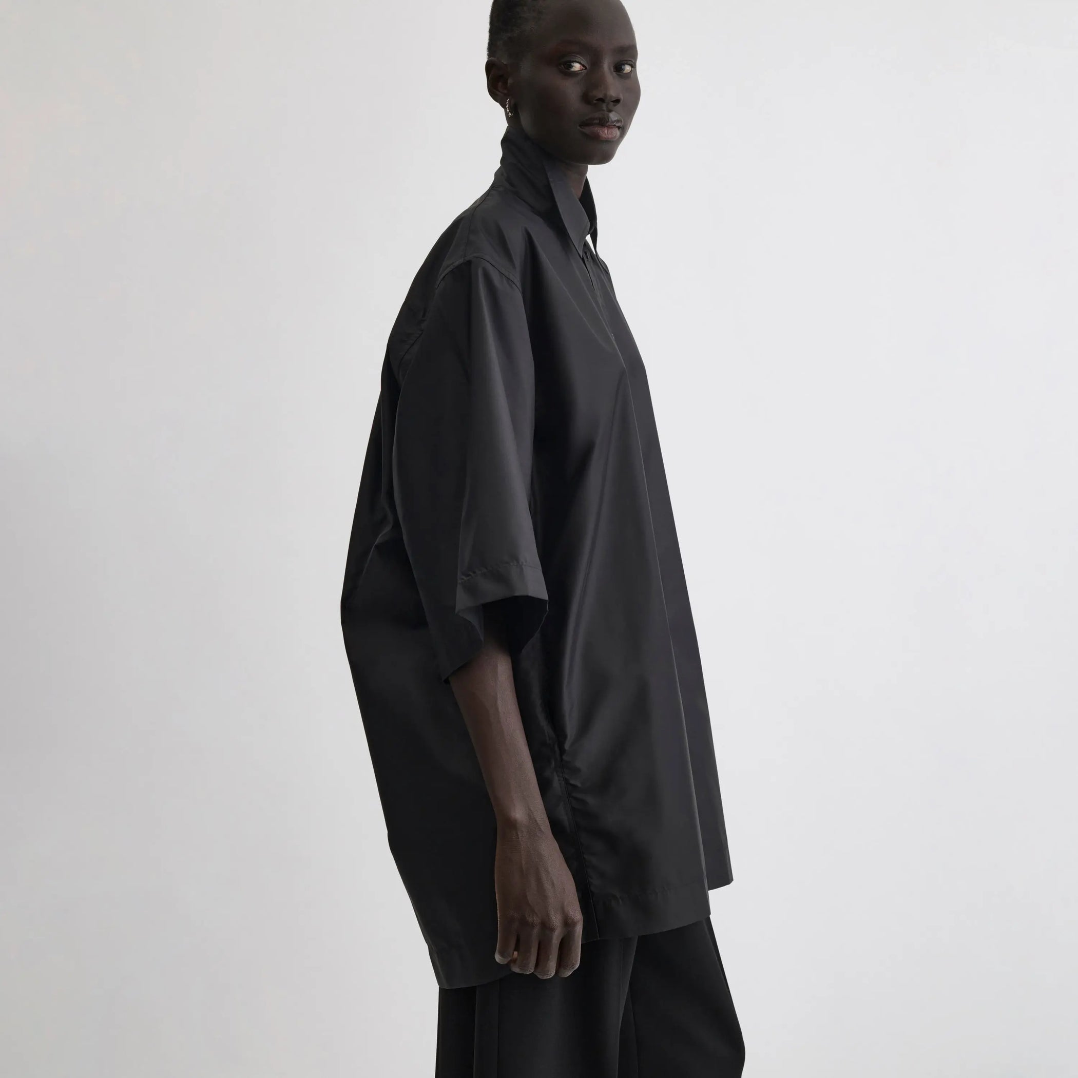 Side view of short sleeve shirt in black technical taffeta