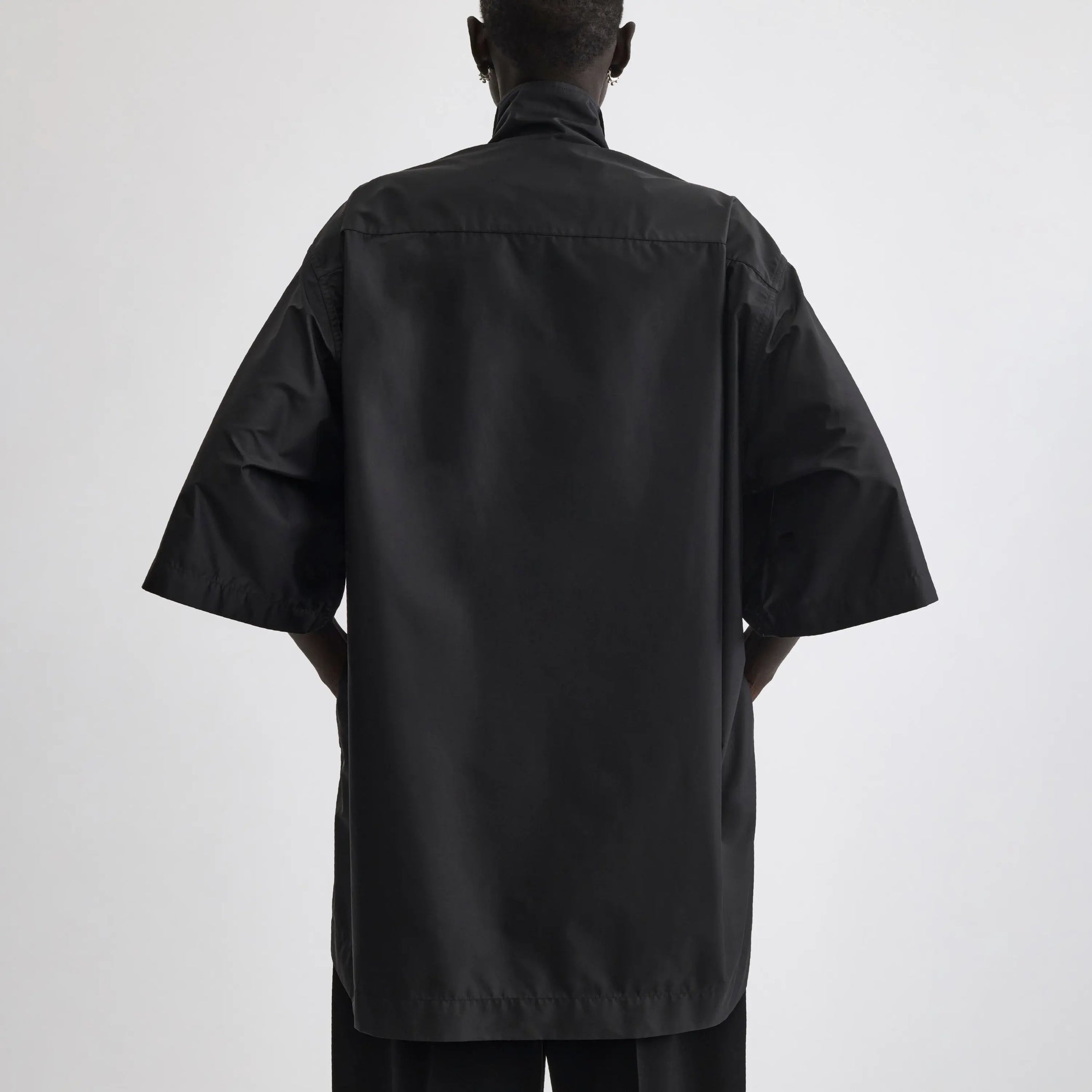 Back view of short sleeve shirt in black technical taffeta