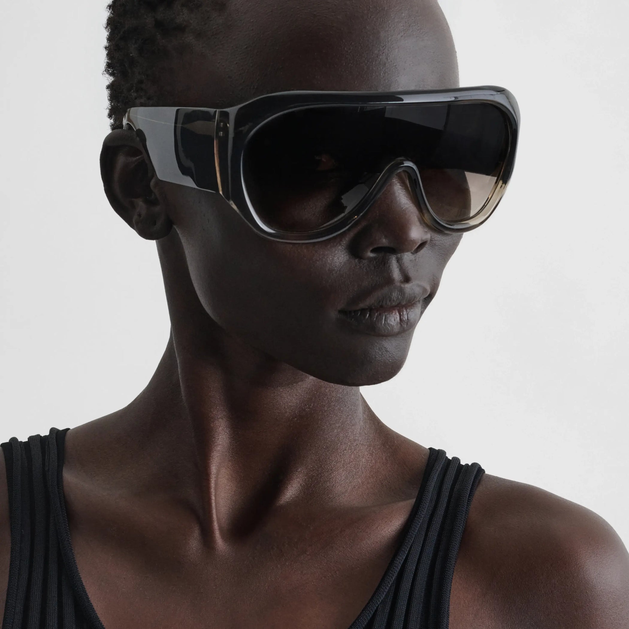 Side view of model wearing bombé sunglasses in fume acetate.