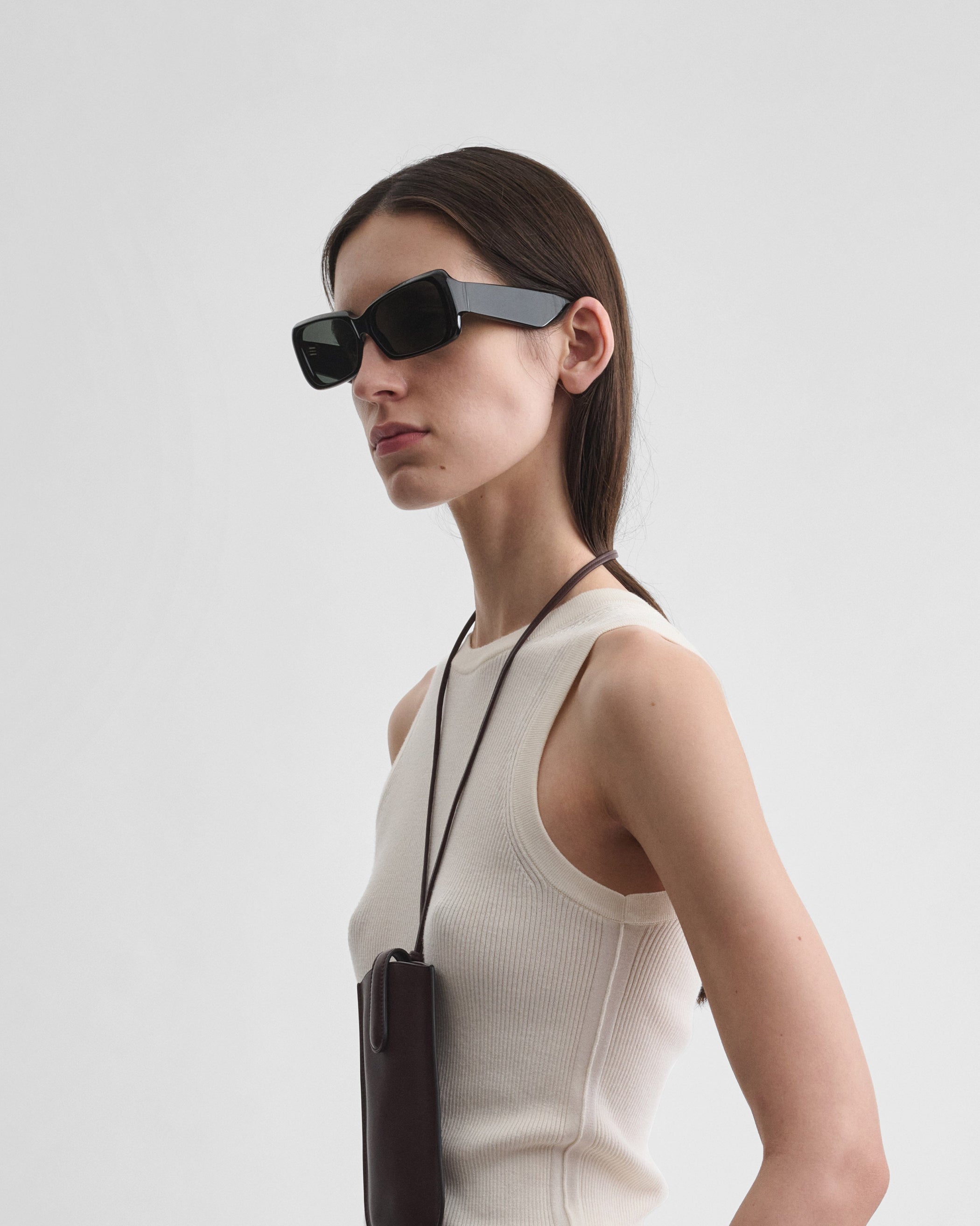 Side view of model wearing SCORE SUNGLASSES in black acetate