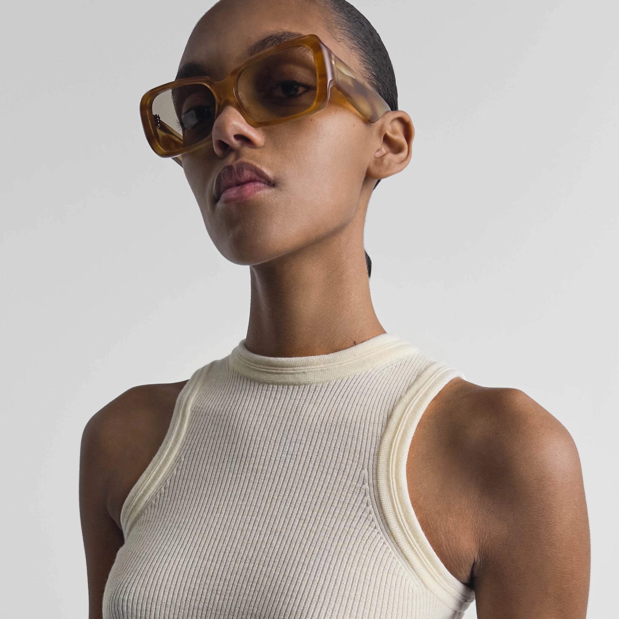 Closeup view of model wearing score sunglasses in tortoiseshell.