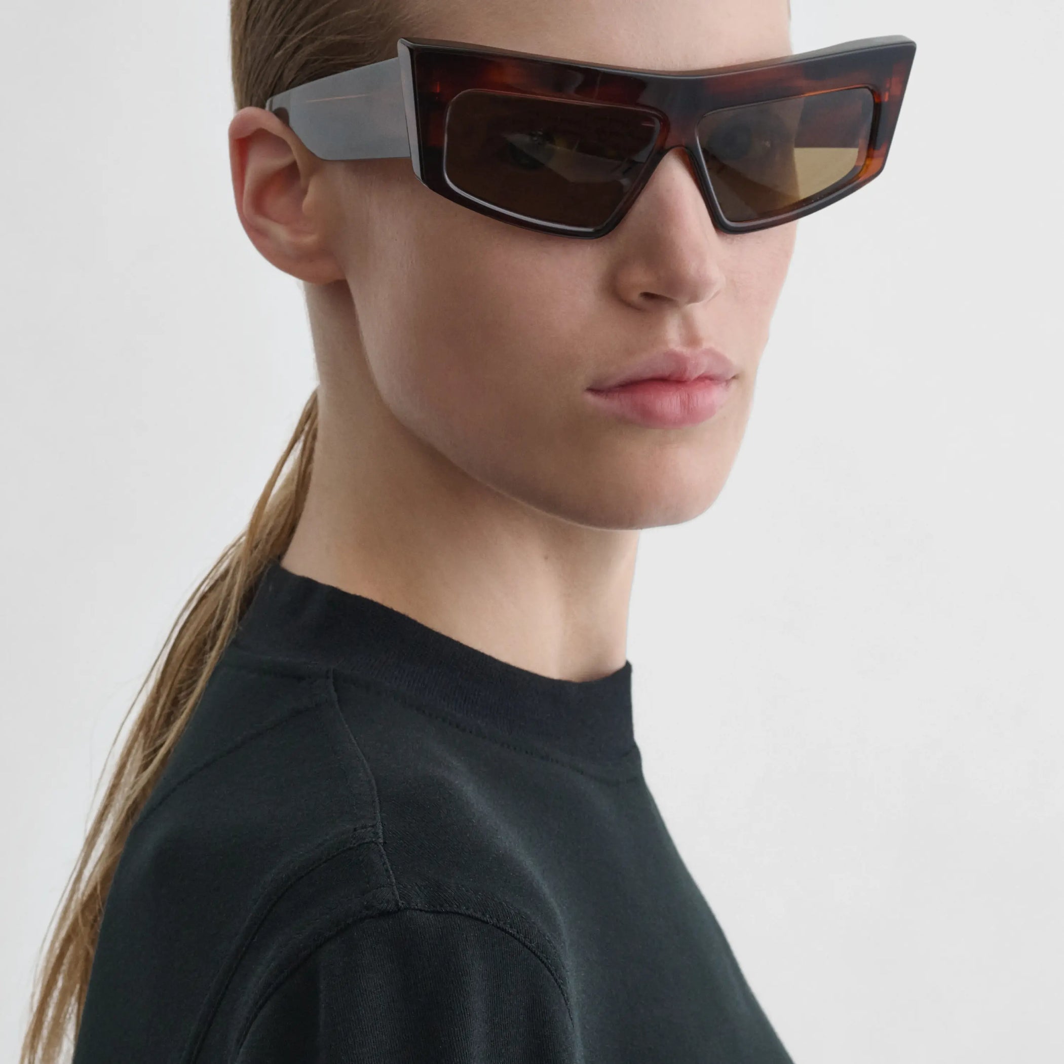 Angled view of model wearing cruise sunglasses in tawny tortoiseshell.