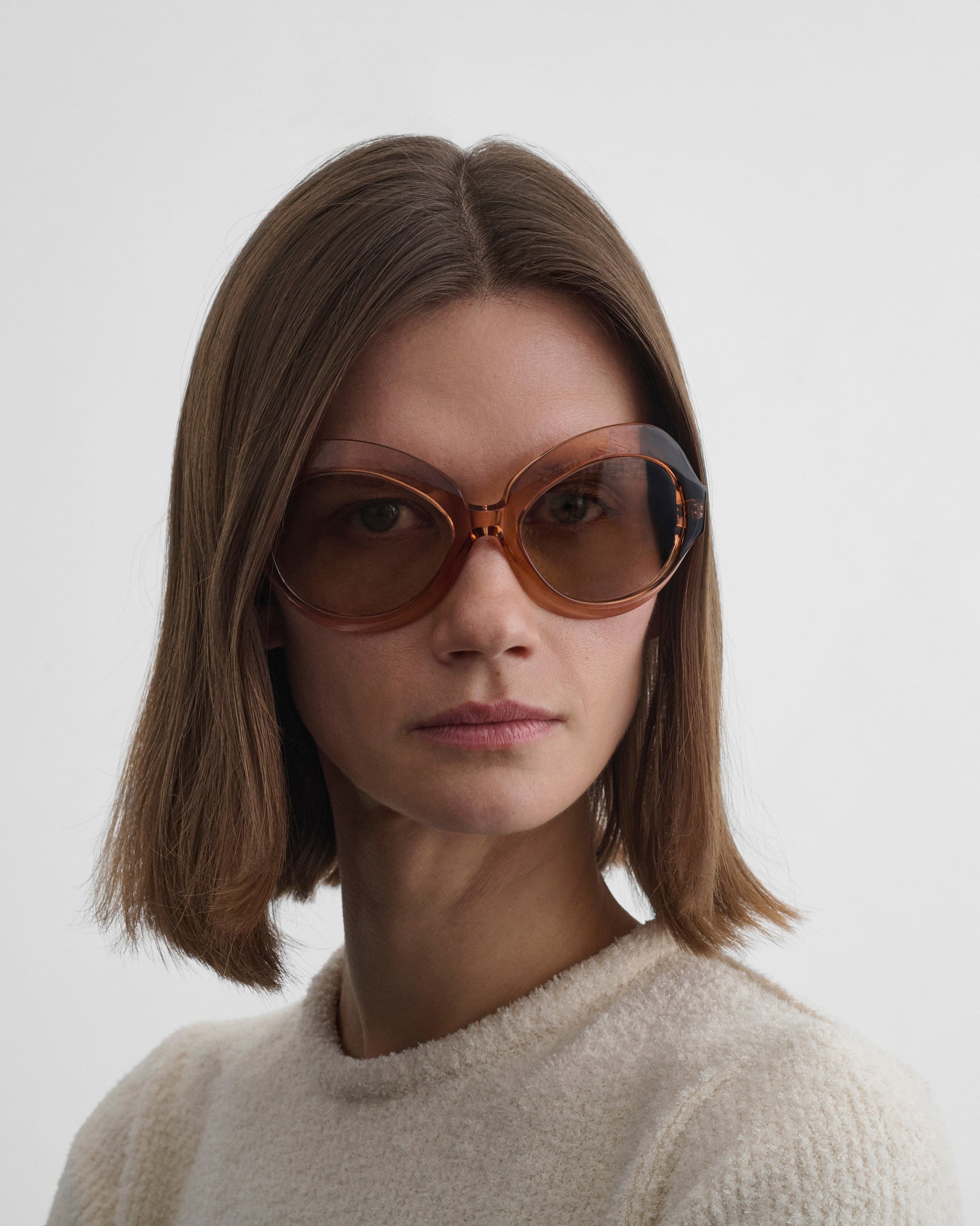 Front view of model wearing BLISS SUNGLASSES in raspberry acetate