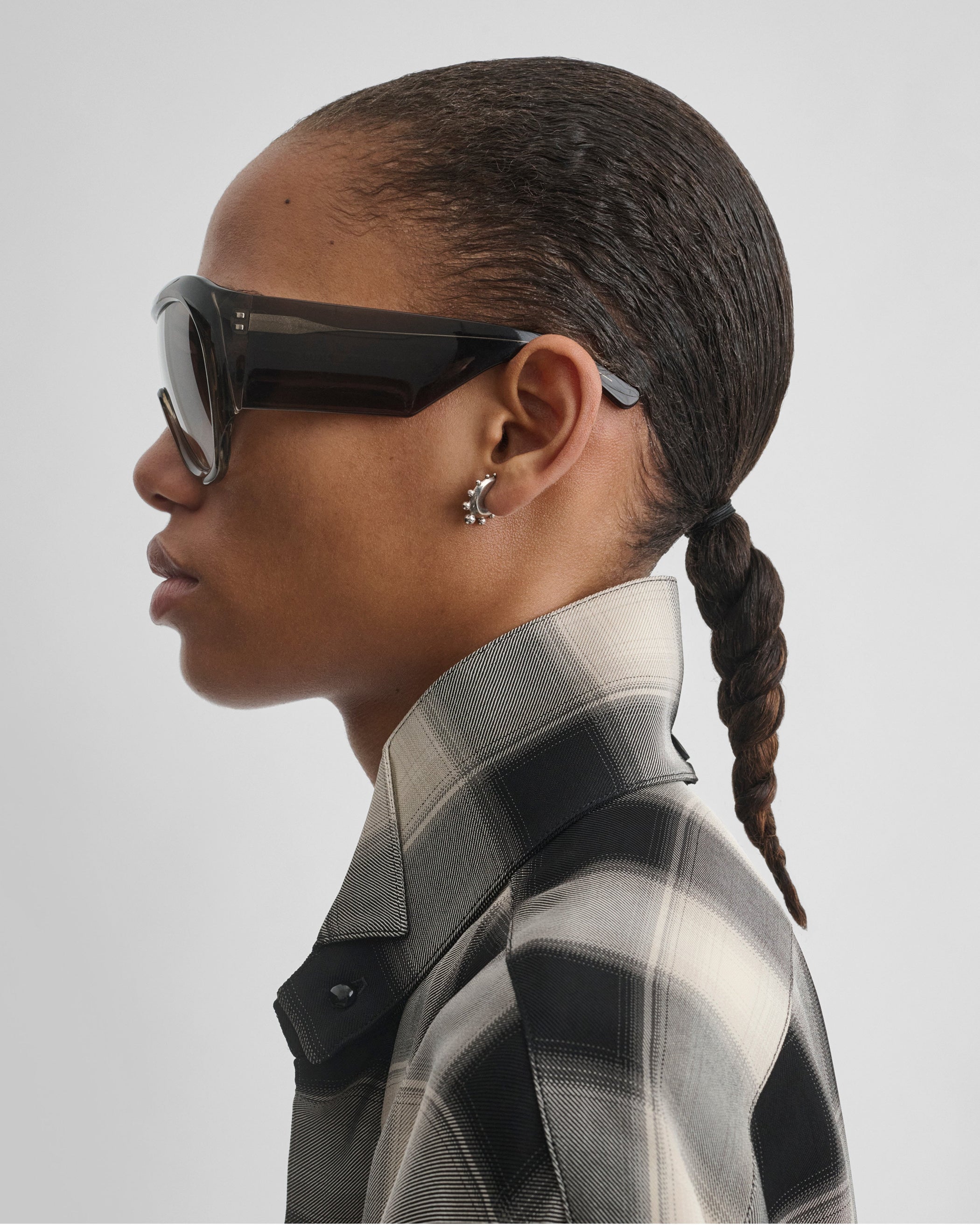 Side view of model wearing BOMBÉ SUNGLASSES in fume acetate