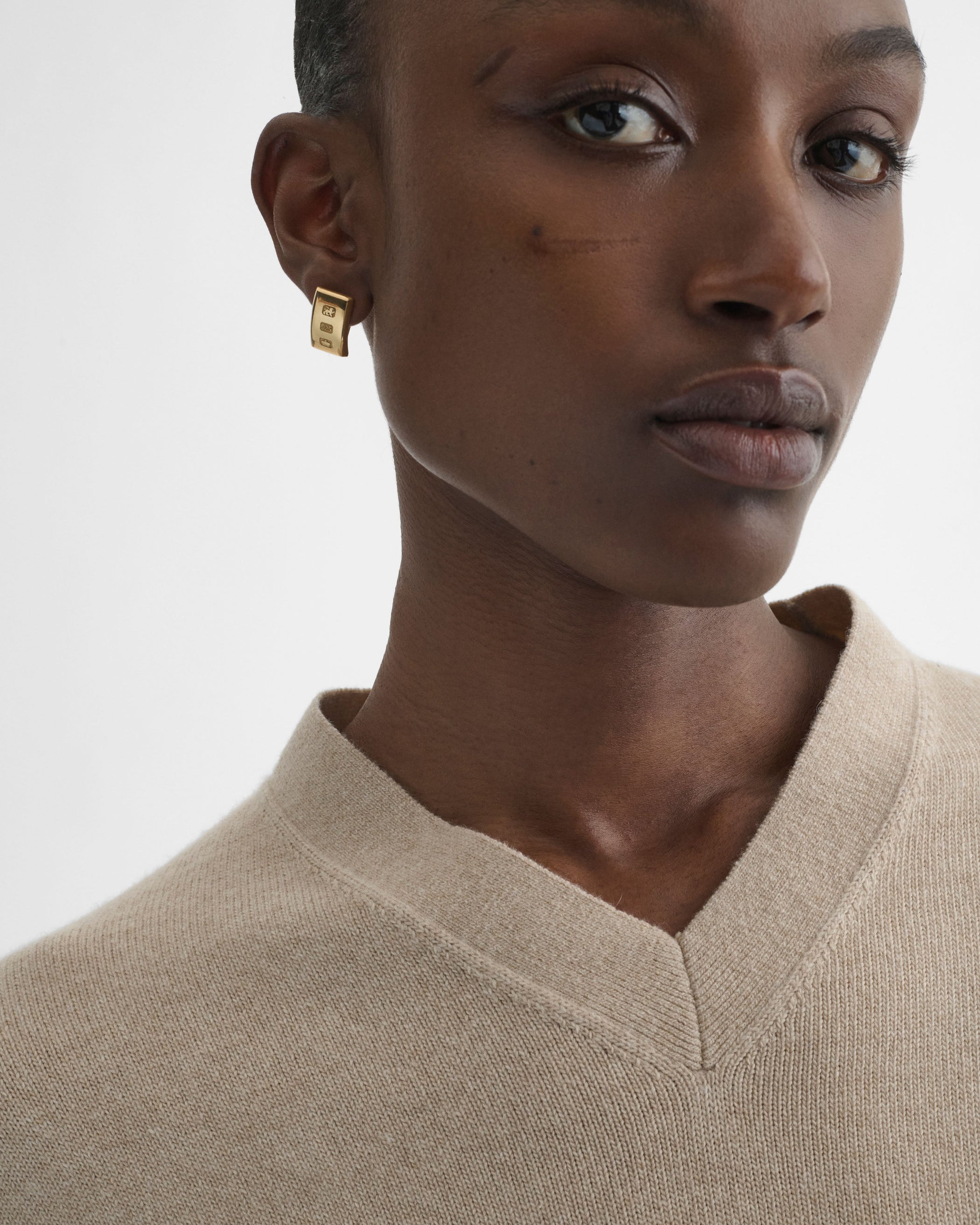 Front view of model wearing HALLMARK EARRINGS in gold plated sterling silver