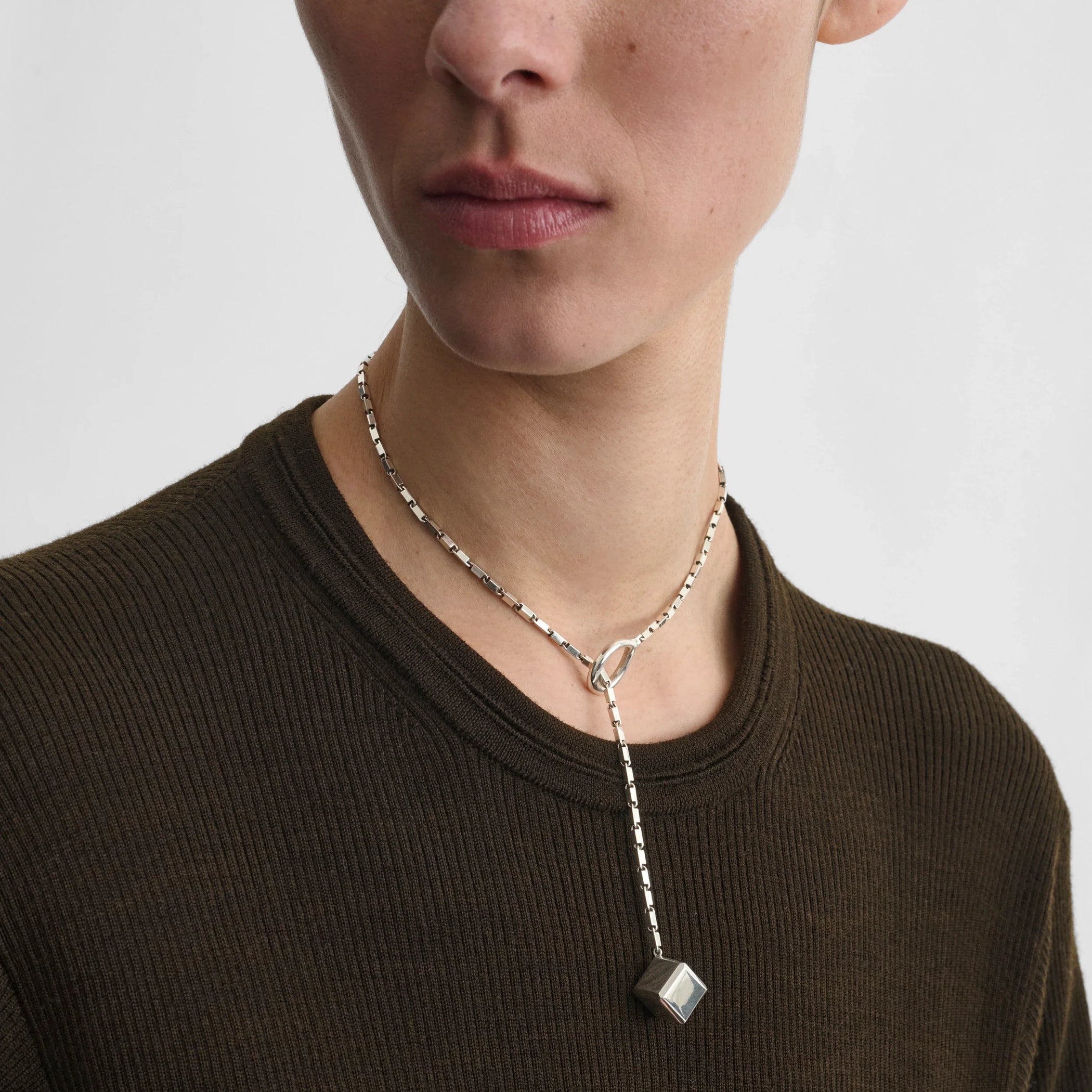 Front view of model wearing hoop tie pendant in sterling silver.
