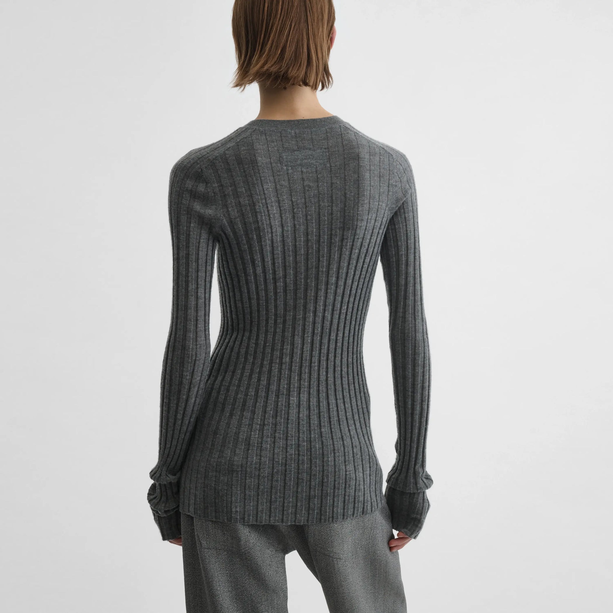 Back view of model wearing Wide Rib Crewneck in grey.