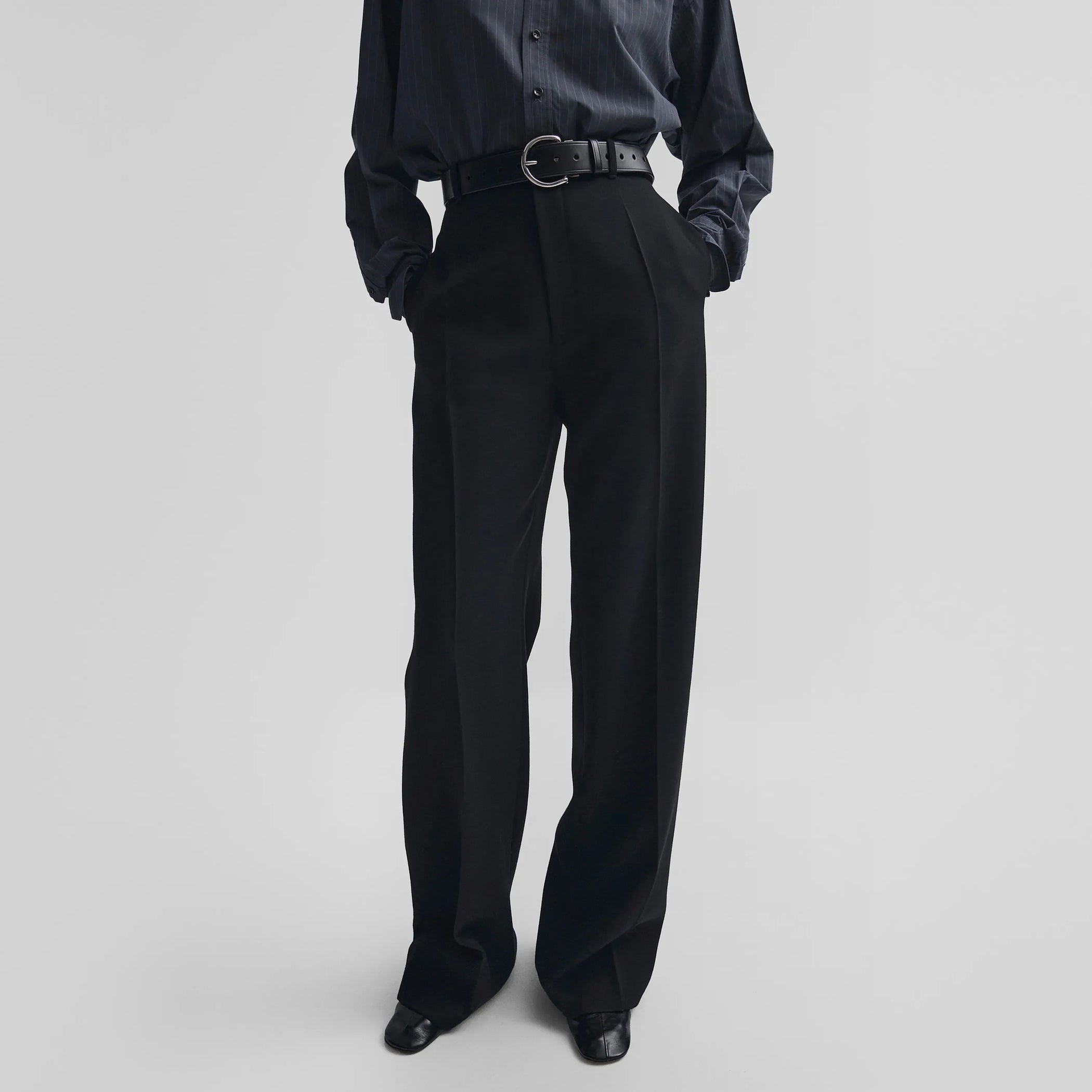 Front view of zip trousers in black wool