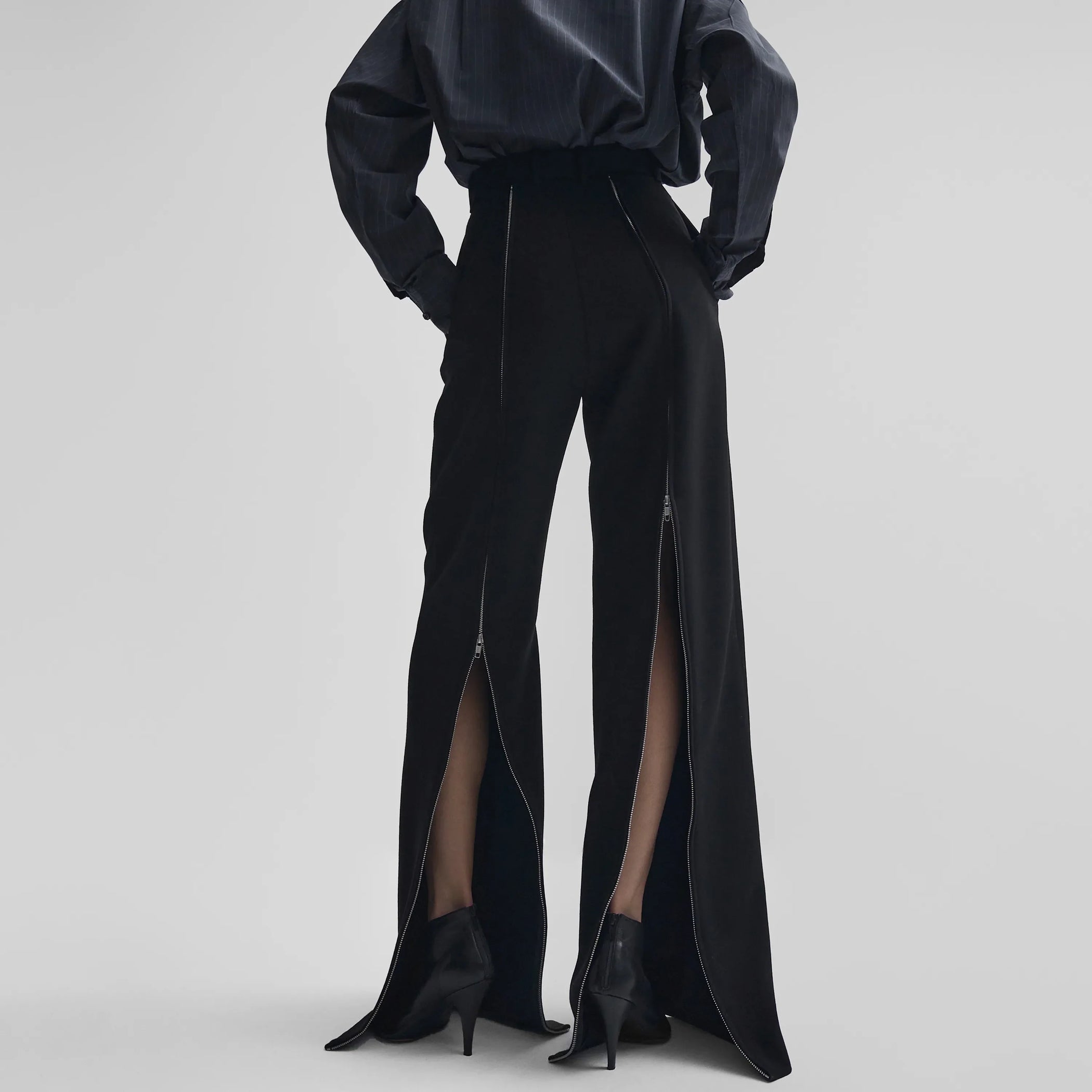 Back view of zip trousers in black wool
