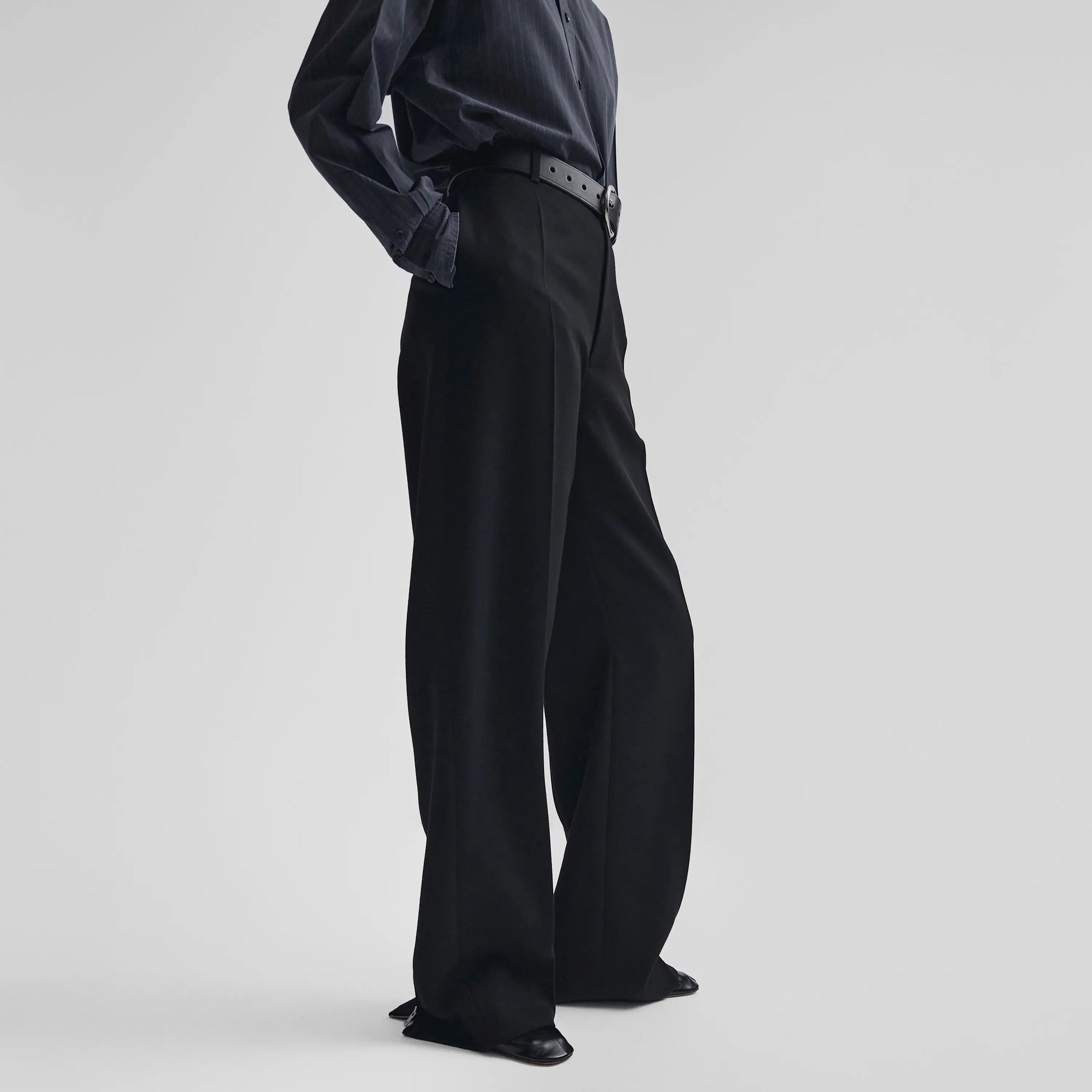 Side view of zip trousers in black wool