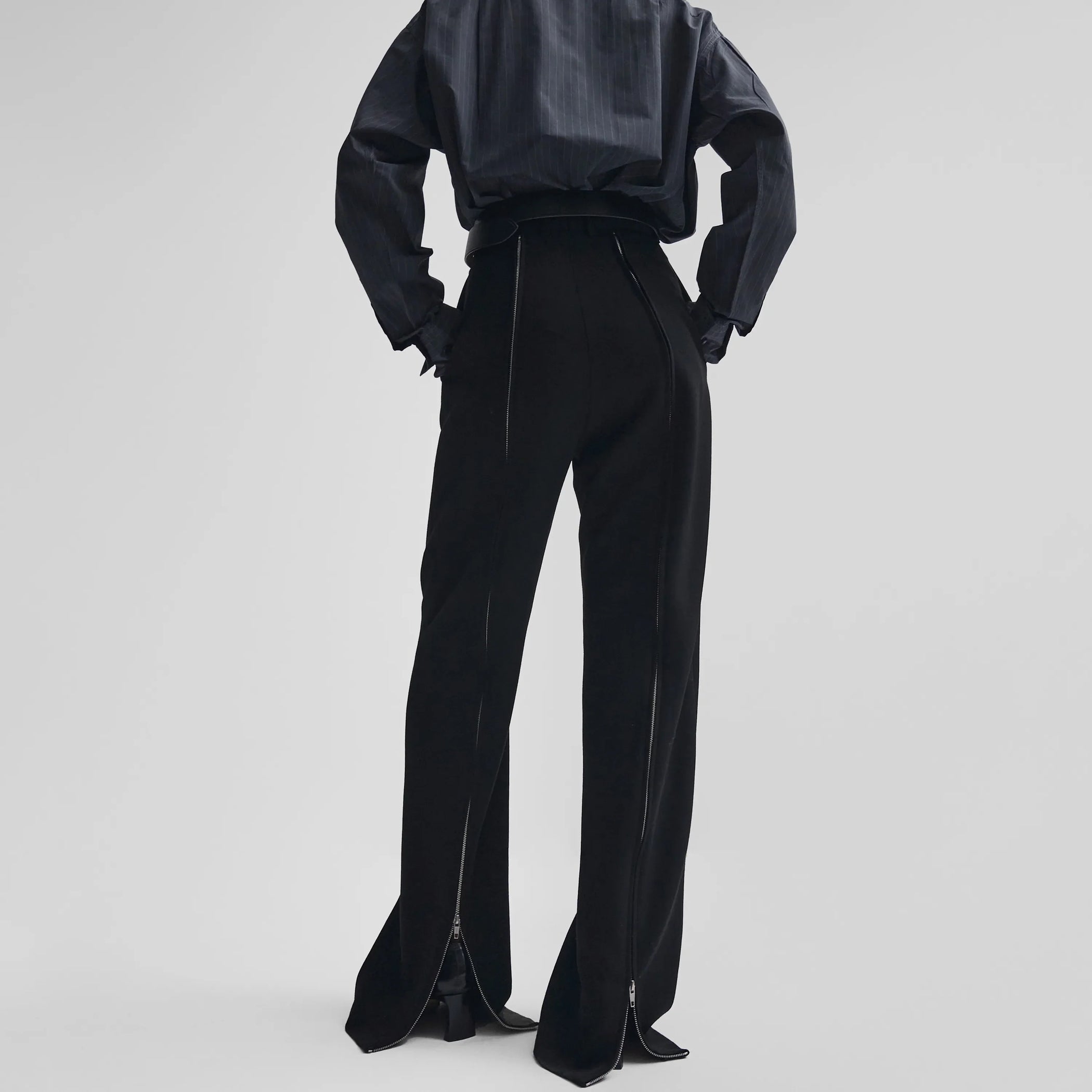 Back view of zip trousers in black wool