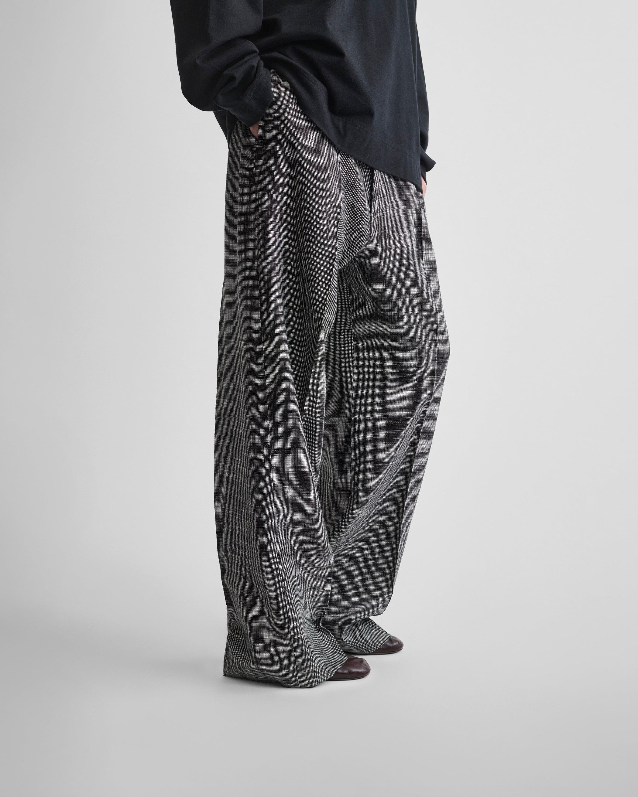Side view of model wearing DROP TROUSERS in blue grey melange woven viscose