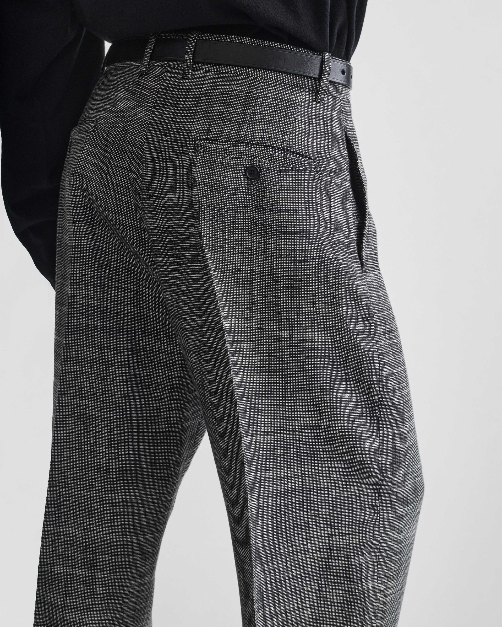 Back detail view of model wearing DROP TROUSERS in blue grey melange woven viscose