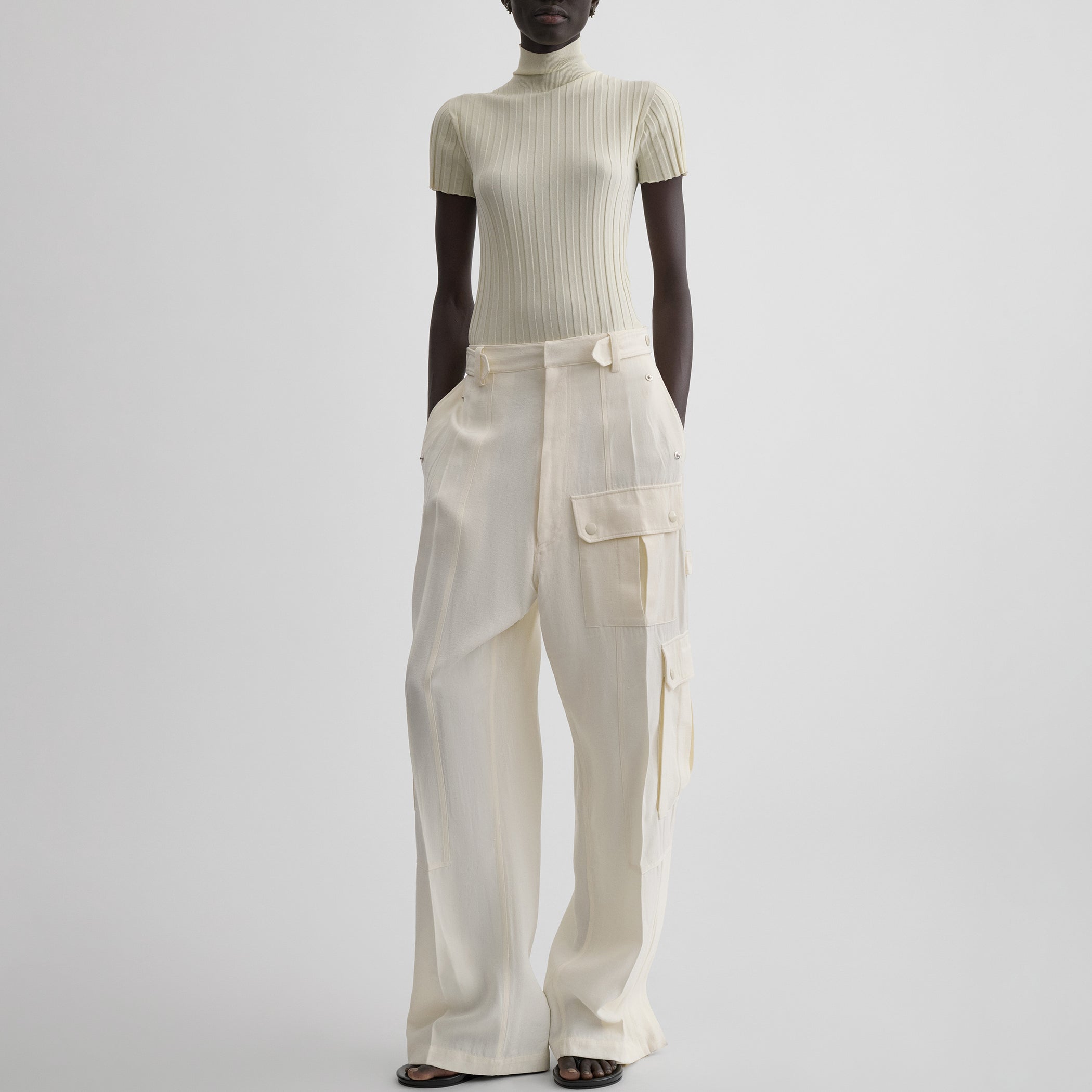 Side view of model wearing PATCH POCKET CARGO TROUSERS in parchment viscose silk