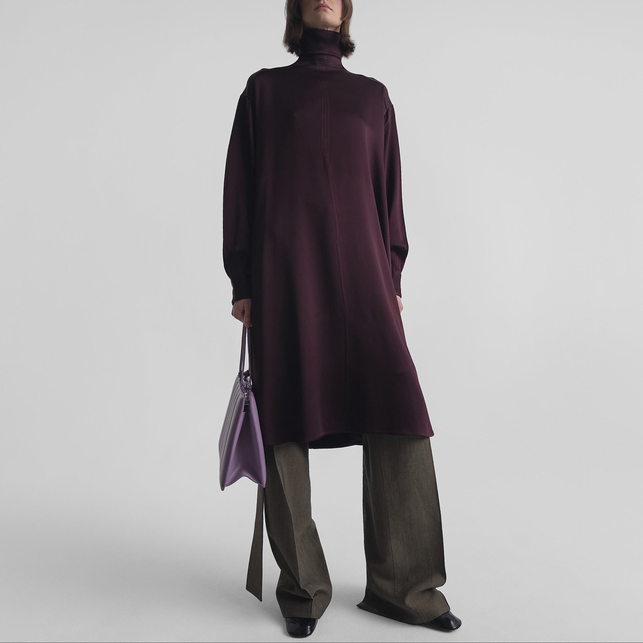 Front view of model wearing DRESS in dark berry satin back crepe