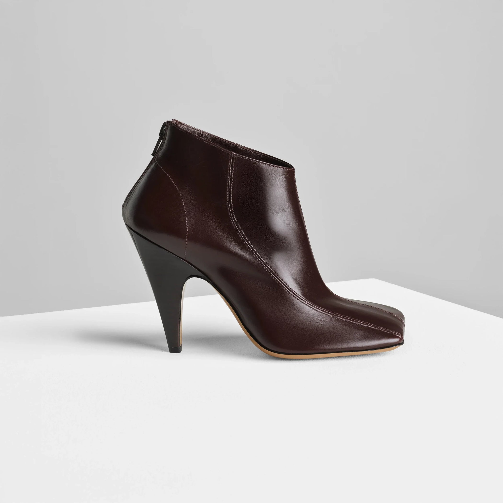 Side view of tilt ankle boot in oxblood leather.
