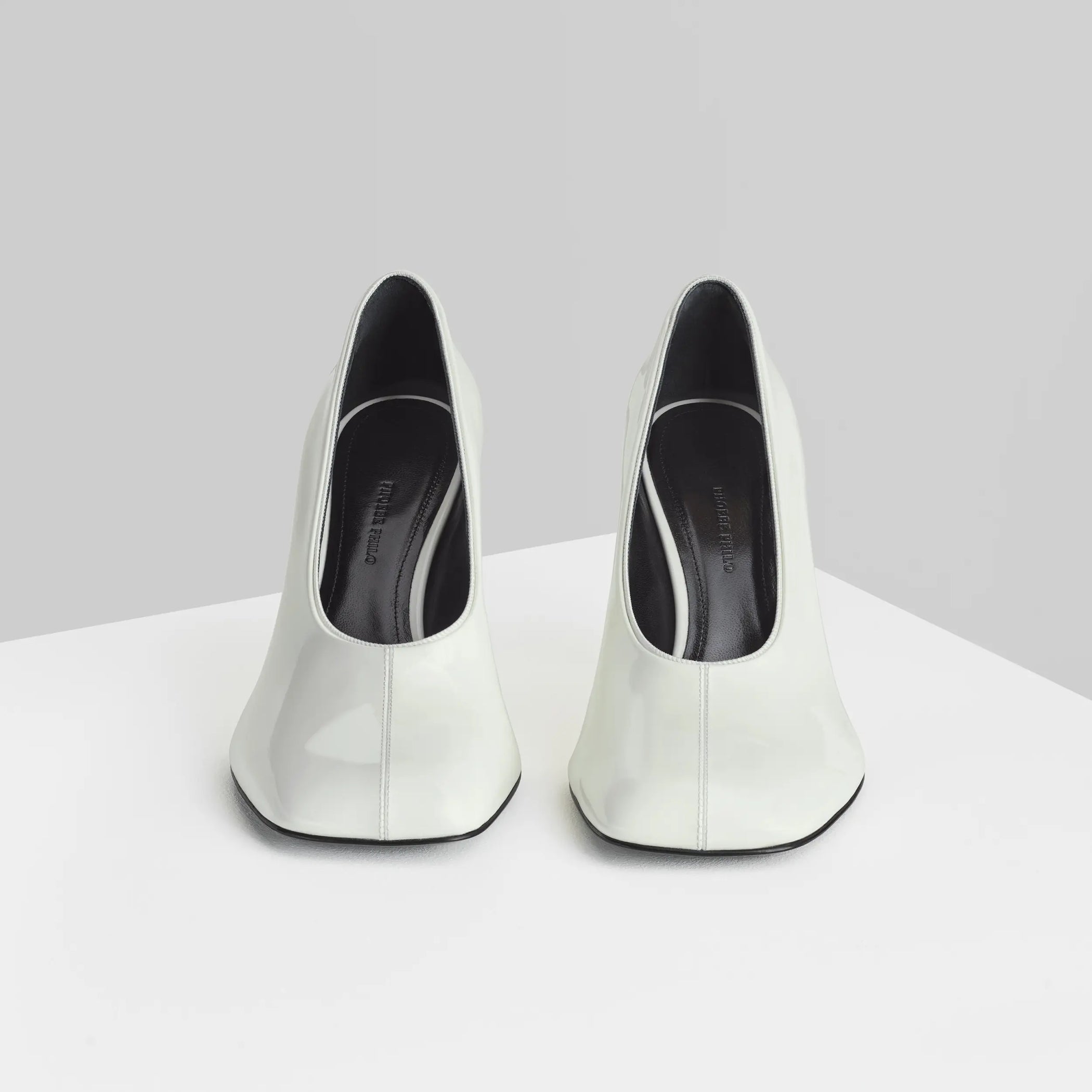 Front view of soft pump 90 in white patent leather
