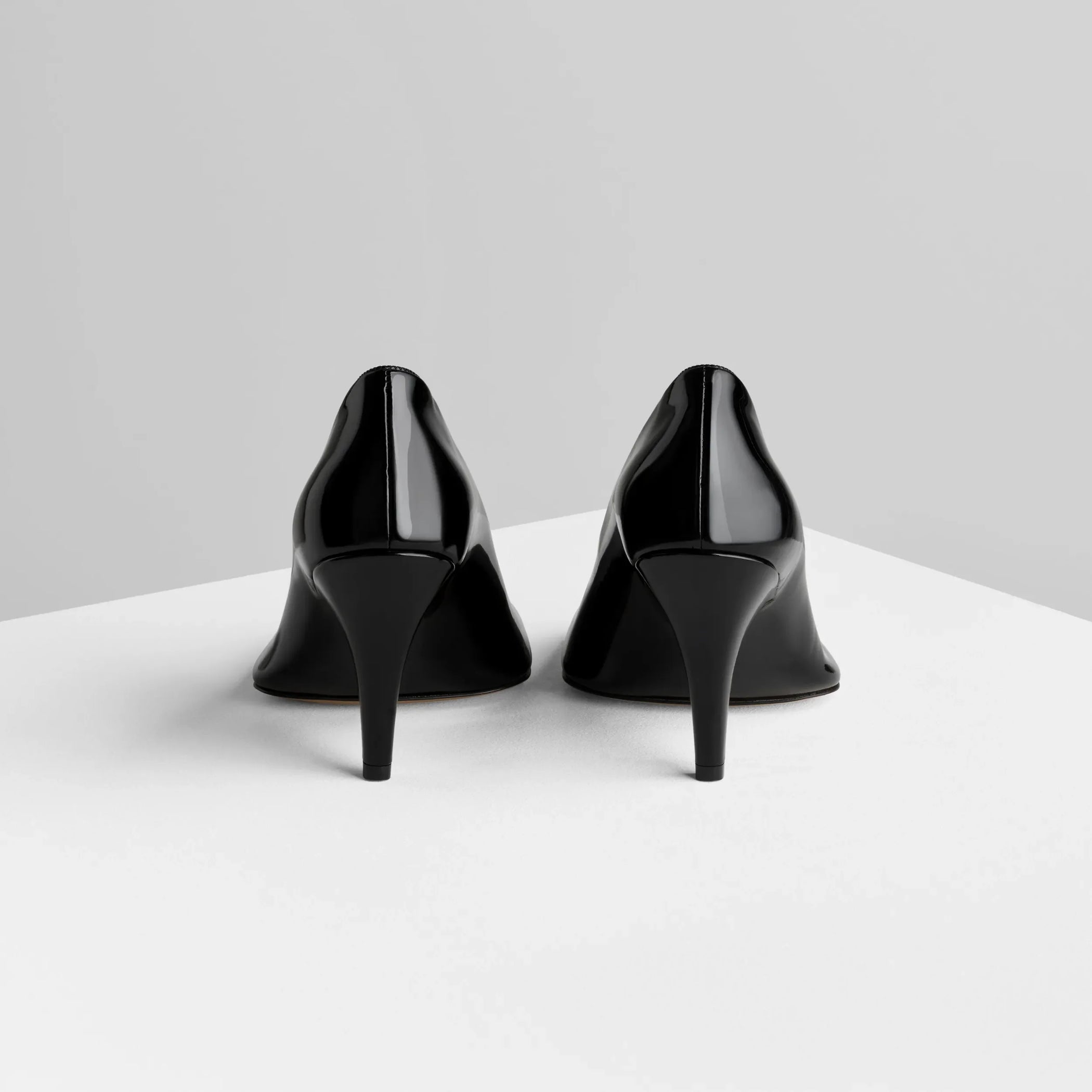 Back view of soft pump 90 in black patent leather.