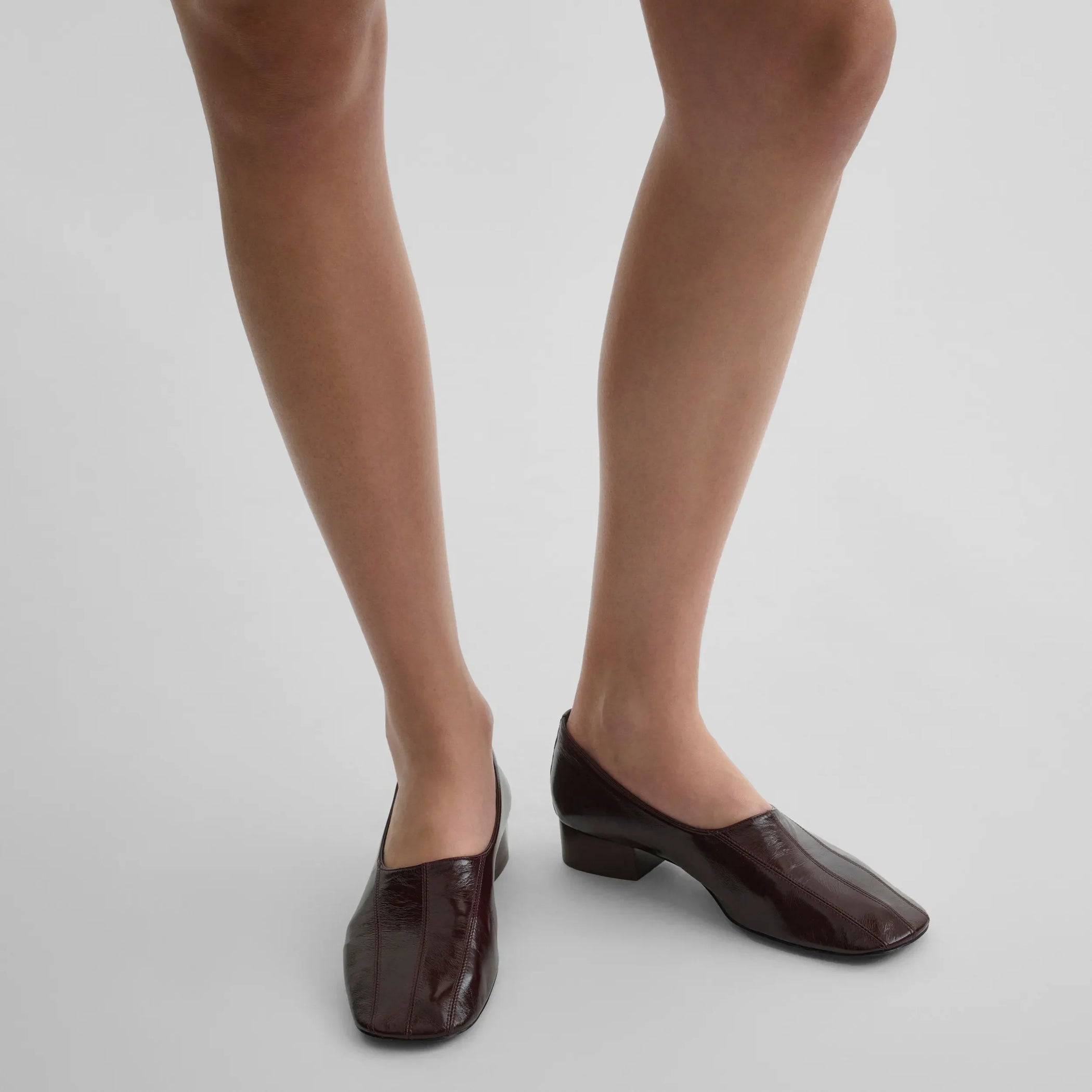 Top view of model wearing club slipper in oxblood shiny leather