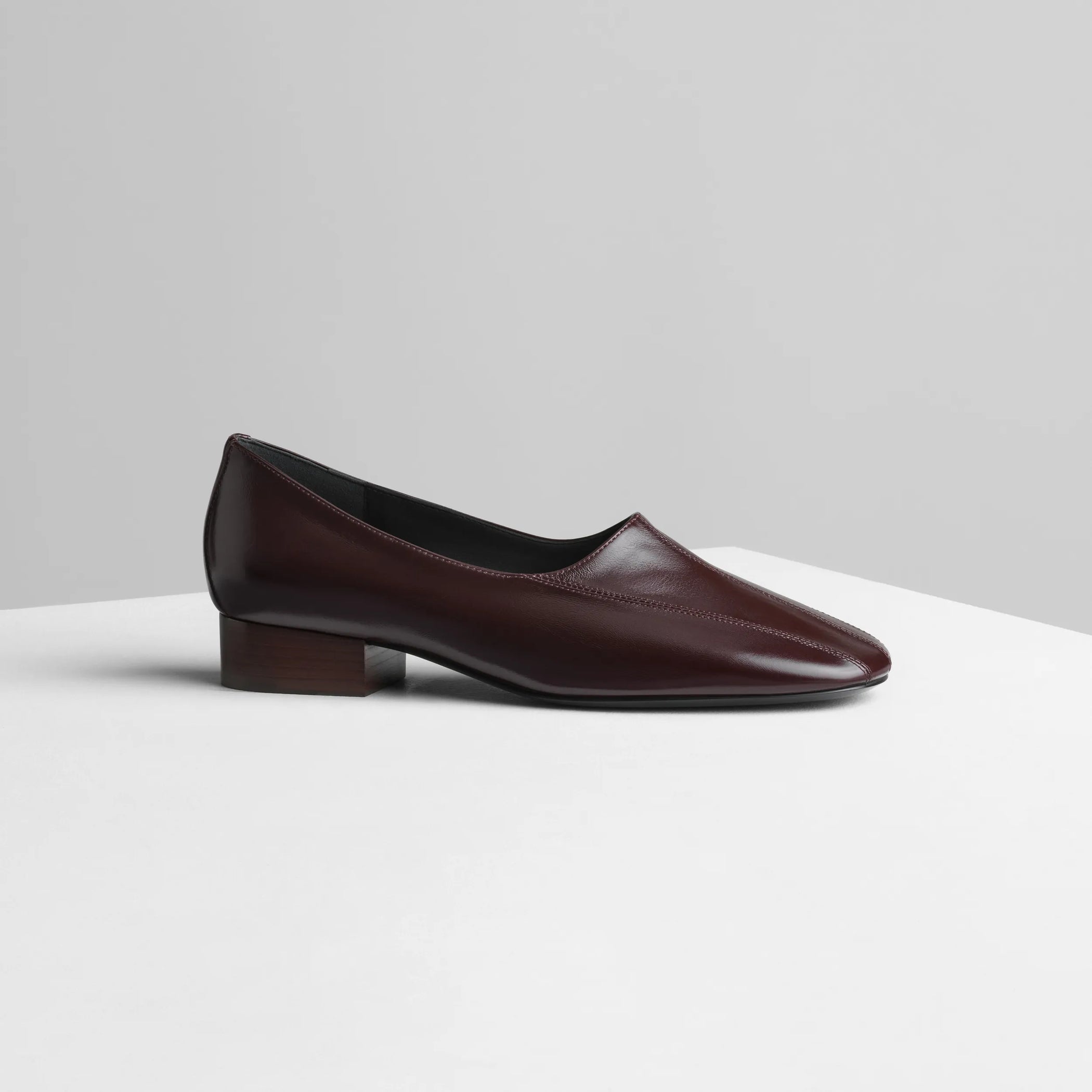 Side view of club slipper in oxblood shiny leather