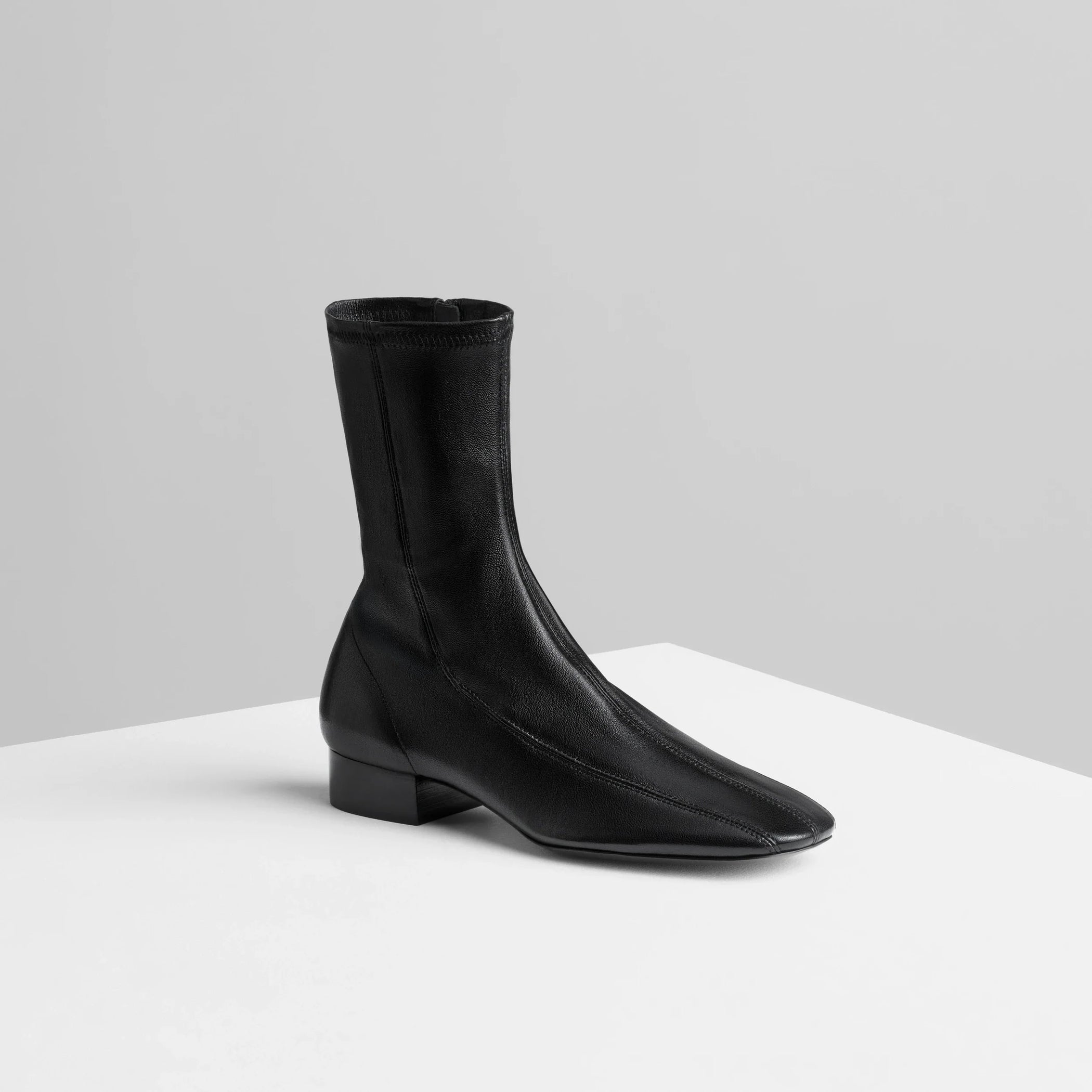 Angled view of club boot 30 in black stretch nappa leather.