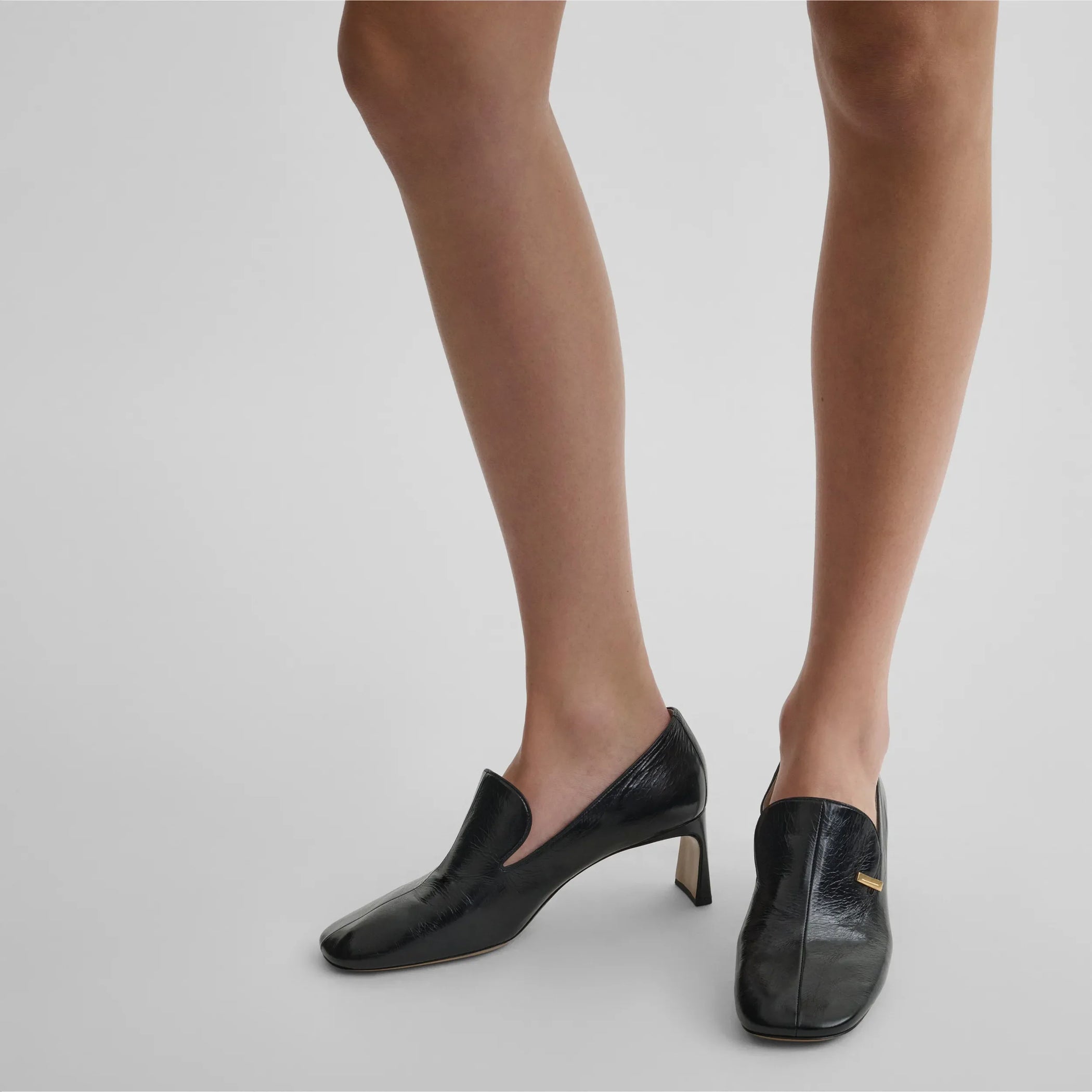 Front view of model wearing club loafer 60 in black leather.