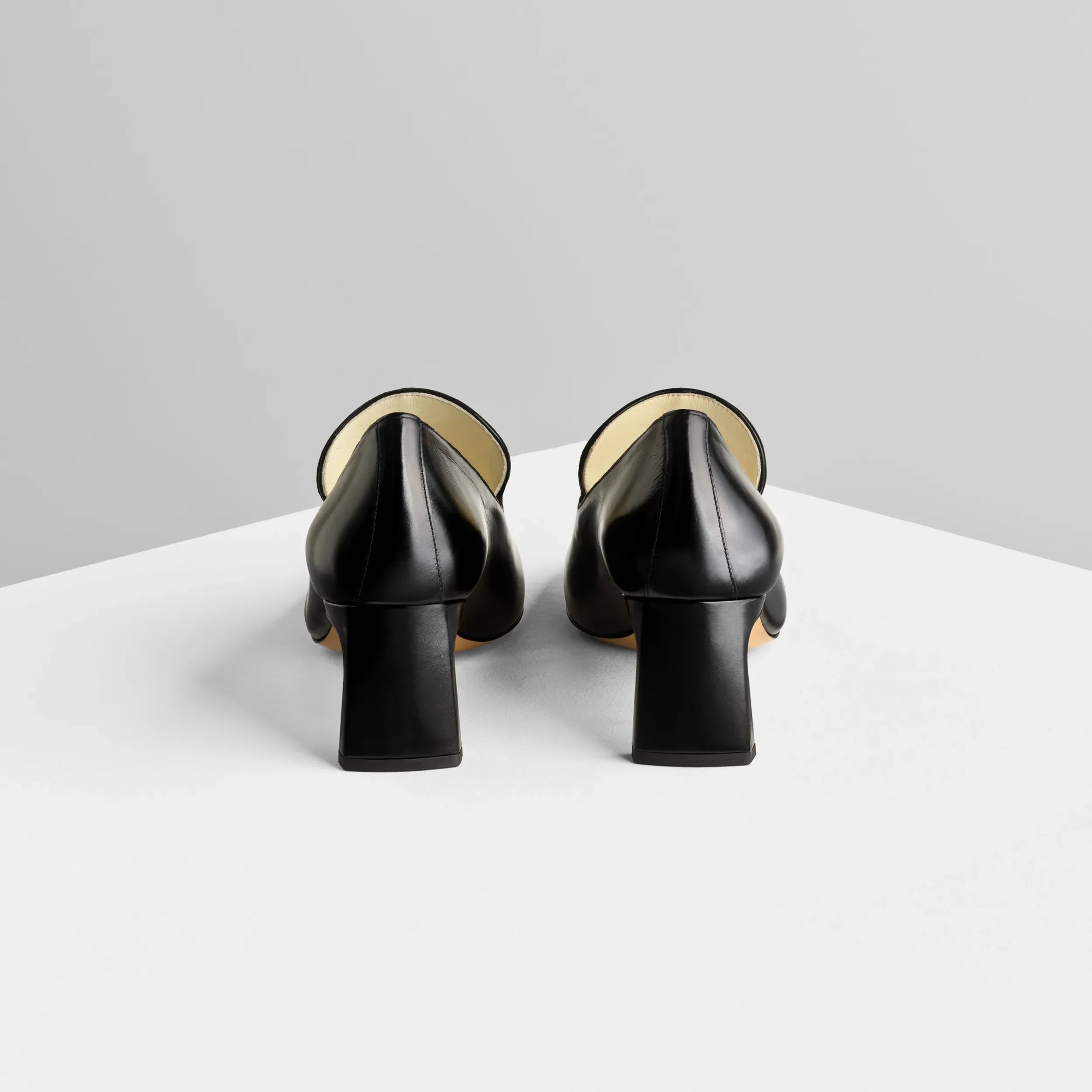 Back view of club loafer 60 in black leather.