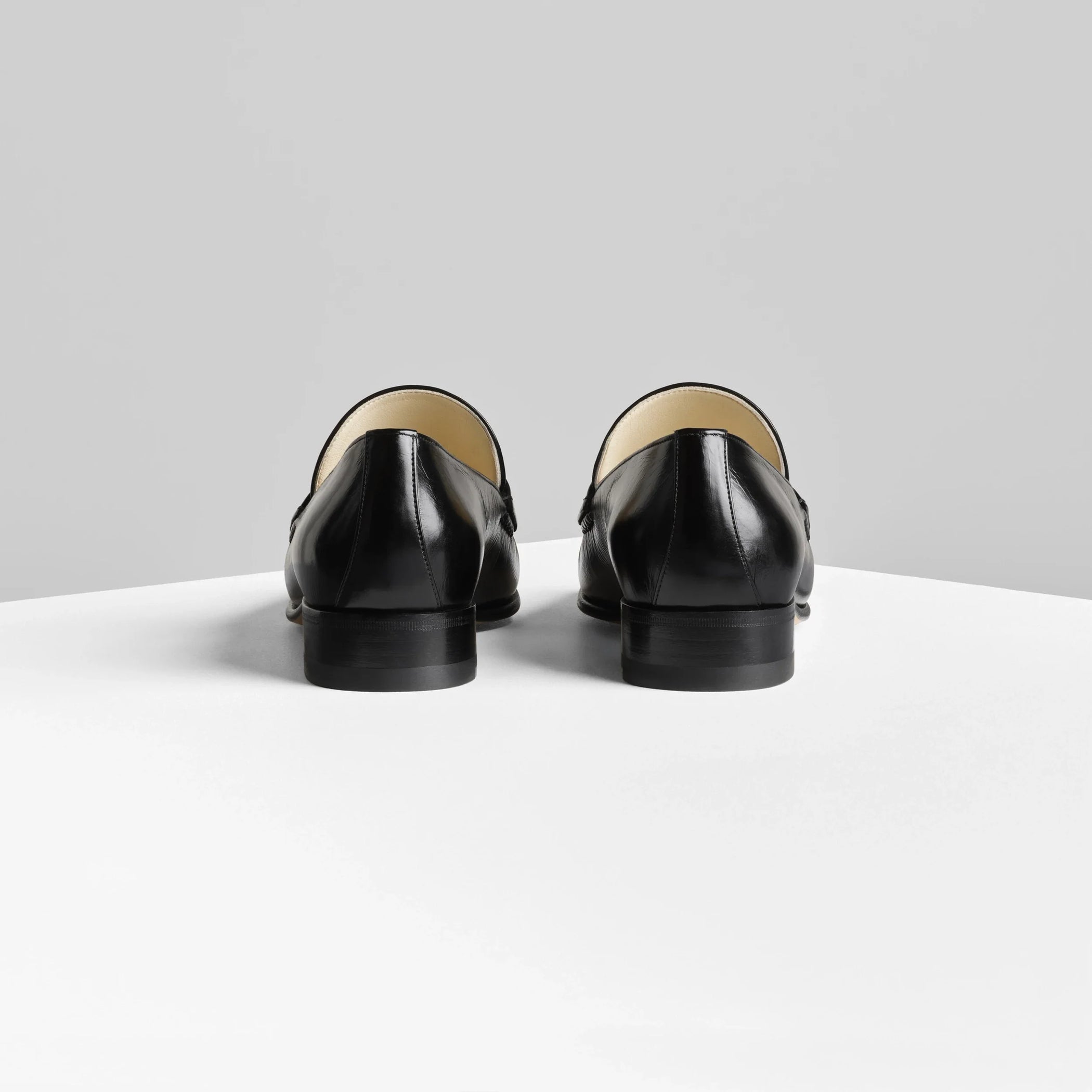 Back view of man’s loafer in black leather.