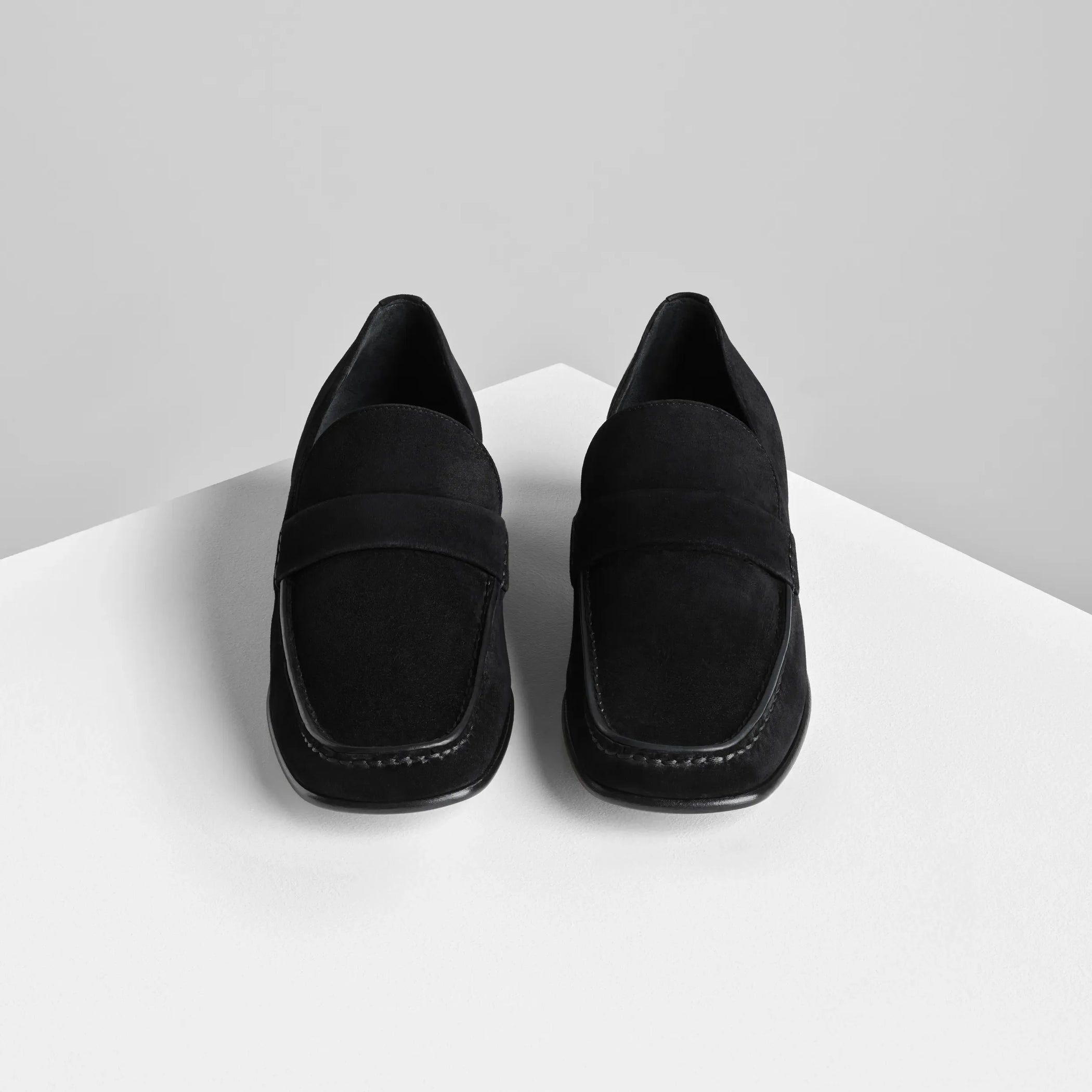 Front view of man&#39;s loafer in black suede leather.