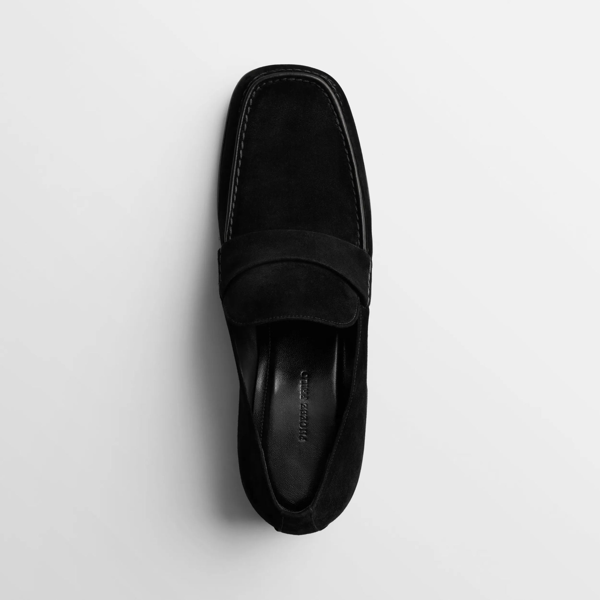 Top view of man&#39;s loafer in black suede leather.