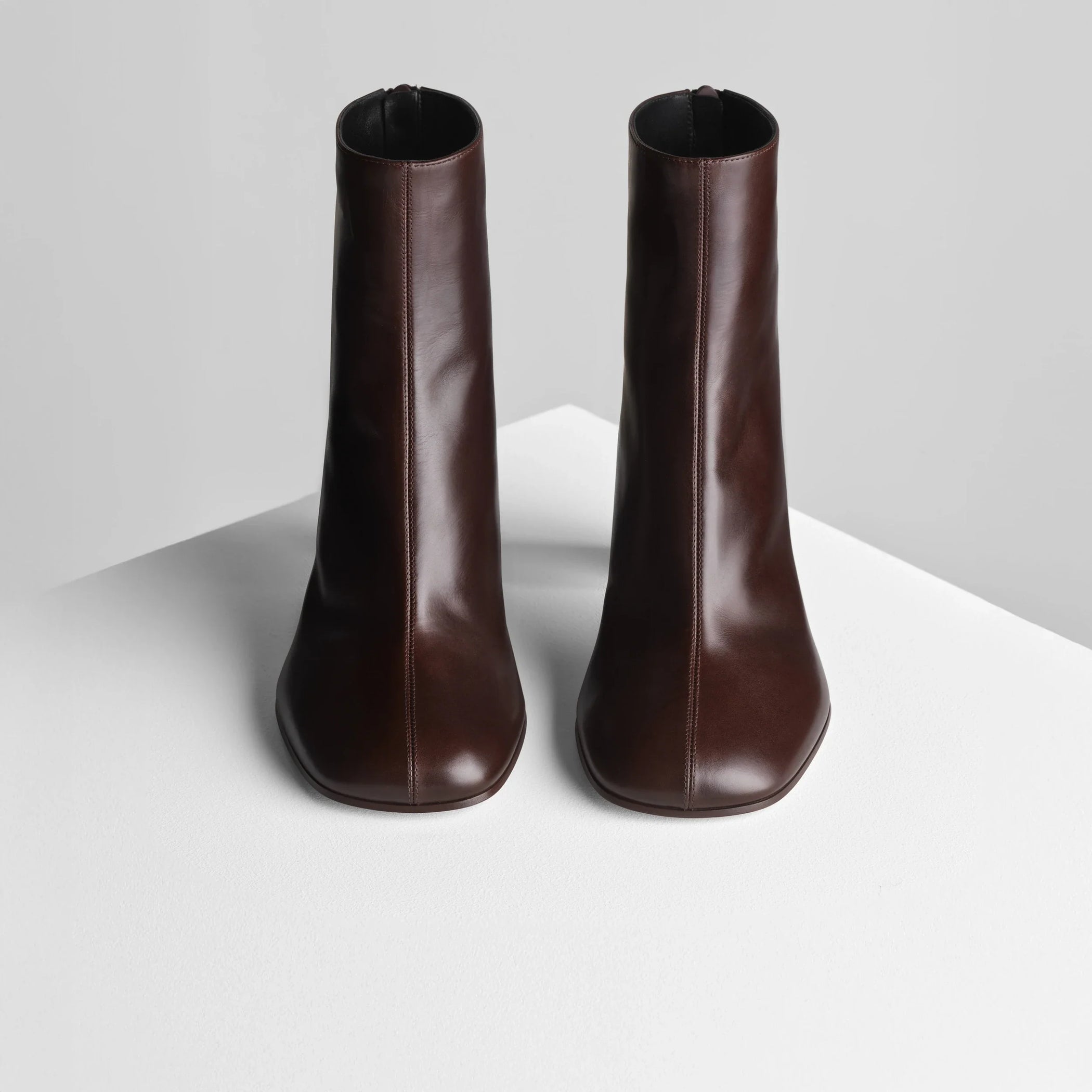 Front view of tug ankle boot in plum brown leather.