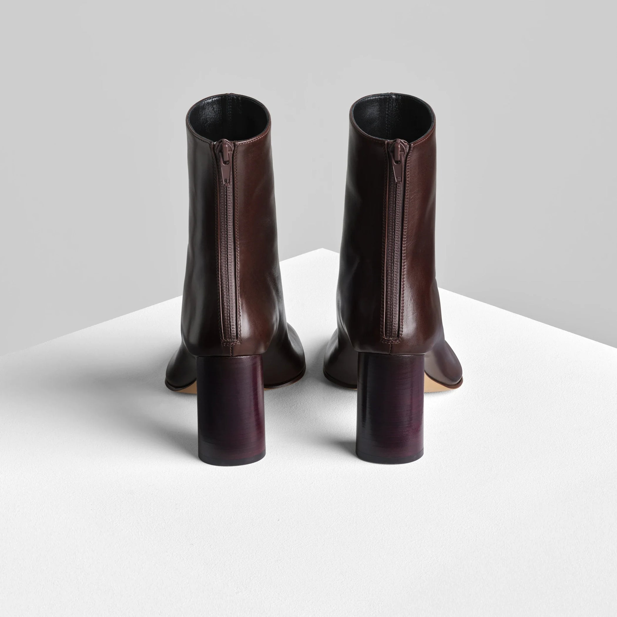 Back view of tug ankle boot in plum brown leather.