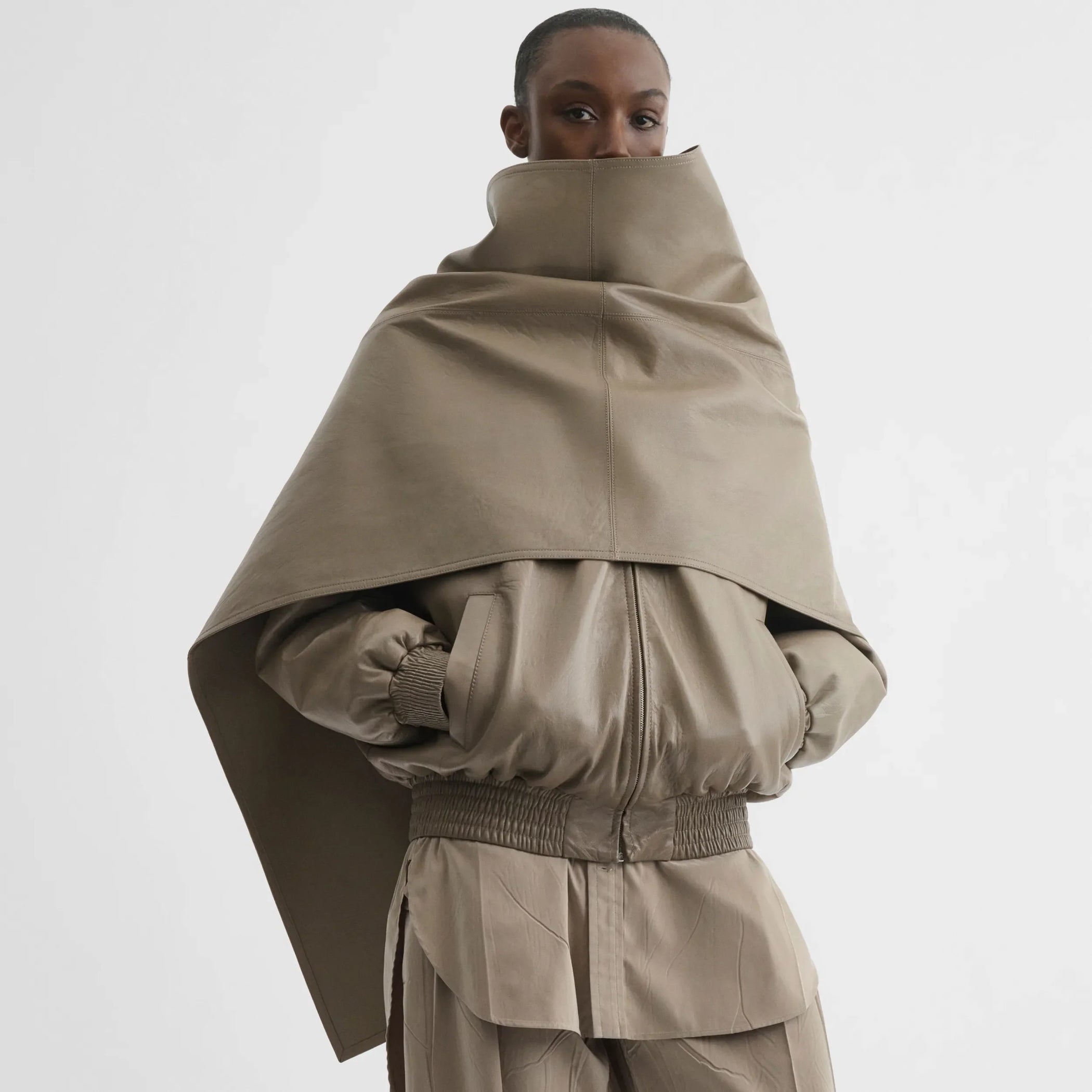 Front detail view of jacket with attachable scarf in mastic leather