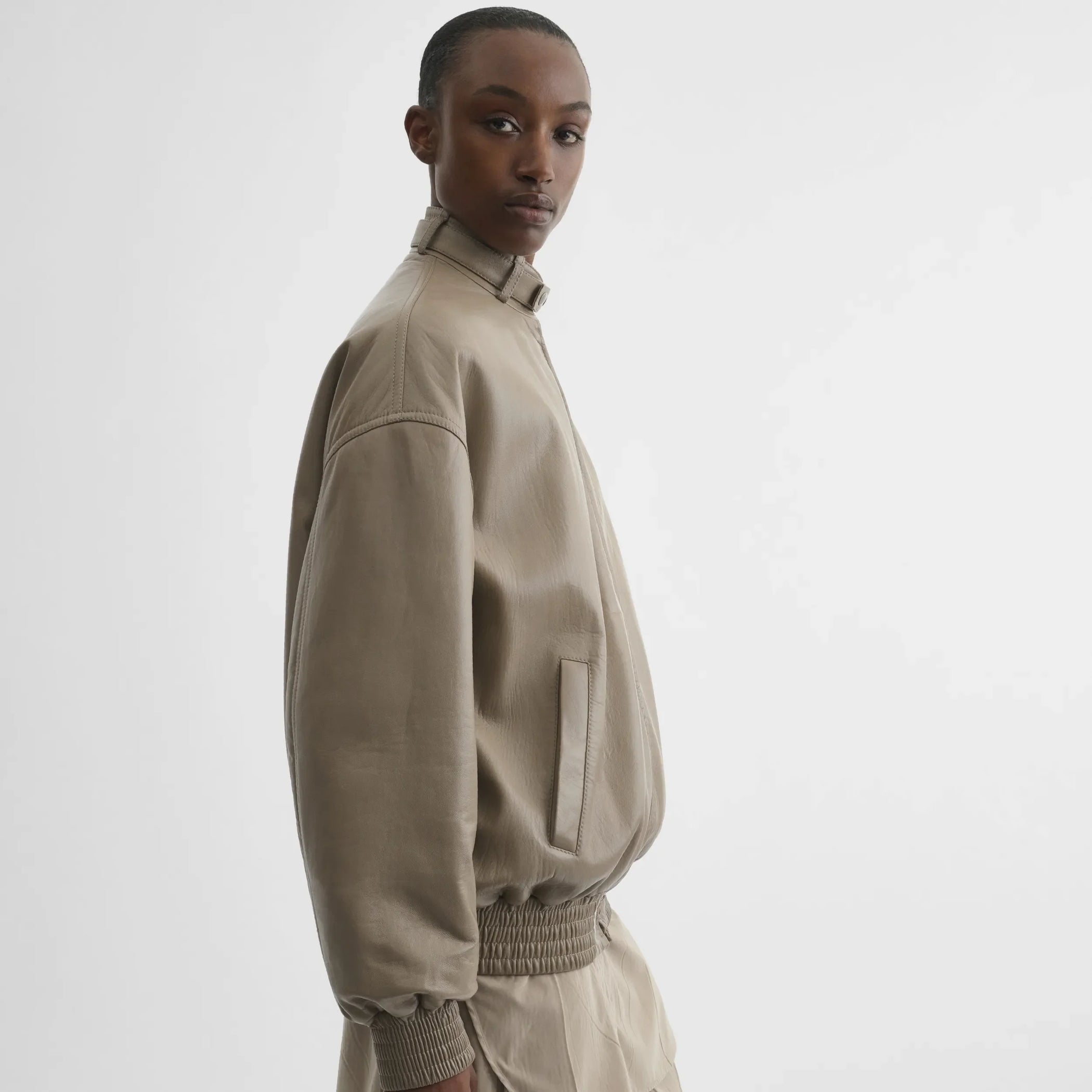 Side view of jacket with attachable scarf in mastic leather